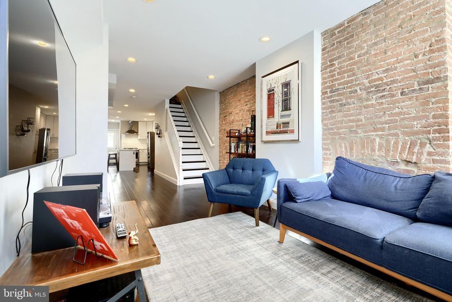 Welcome to 1404 Towson St, a remarkable CHAP renovation that will save you thousands on your taxes! Renovated in 2020, this 3bd/2.5ba home offers an open floor plan, rooftop deck, updated kitchen and tons of storage space. Buyers are greeted with hardwood floors that flow throughout the entirety of the main level. The living room is accented by an original fireplace, exposed brick and historical trim. The open floor plan flows nicely into the kitchen, which is perfect for entertaining guests. Equipped with a dual-fuel convection range, this kitchen will please any home chef! Additional amenities include stainless steel appliances, quartz countertops, a tile backsplash and soft-close cabinets. There's also access to the rear patio, which is perfect for entertaining guests and offers the potential for parking if the utility pole is moved. The main level is completed by the powder room, which is convenient for guests. Upstairs offers a spare bedroom with hardwood floors and a spacious closet, and a guest bathroom in the hallway, which offers a shower/tub combo with subway tile and a nice for storage. Laundry is also available on the upper level for added convenience. The primary suite offers exposed brick, hardwood floors and an ensuite bathroom with stall shower. There is also access to the rooftop deck, which offers panoramic views of Baltimore and a direct shot of Fourth of July fireworks! The home is completed with a finished basement that is great for additional living space or a third bedroom and offers ample storage. If you want to live in the heart of all of the action in Locust Point, look no further than 1404 Towson St!