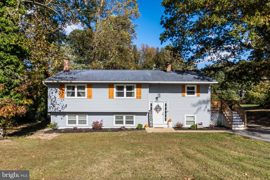 This beautifully updated split-foyer in Hollywood strikes the perfect balance between classic charm and modern style. Step inside to find refinished original hardwood floors, an open-concept main level, and sun-filled spaces that make the home feel warm and welcoming. The kitchen impresses with granite countertops, stainless steel appliances, and soft-close cabinetry, and flows seamlessly into the expanded dining area with a new sliding glass door leading to a 10’x12’ pressure-treated deck with stairs—perfect for entertaining or quiet mornings outdoors.

Throughout the home, you’ll find all LED lighting, including recessed fixtures and a hallway light with night-light mode, adding energy efficiency and modern appeal.

The main level offers three bedrooms, including a primary suite with a custom-tiled shower, plus an updated hall bath with an oversized vanity and contemporary finishes. The lower level feels bright and open with a spacious family room and walk-out access to the backyard, a fourth bedroom with Jack-and-Jill bath, and a large laundry/utility room with generous storage.

Recent improvements elevate both form and function—a 30’x50’ wood-framed fenced enclosure with welded wire mesh (ideal for pets, gardens, or play) and lot clearing and brush removal that expands usable space along the rear tree line. A home warranty is also included for added peace of mind.

Located in a quiet Hollywood setting with easy access to local marinas, schools, shopping, and NAS Patuxent River, this home stands out for its quality updates, thoughtful improvements, and move-in-ready condition. Jump on it!