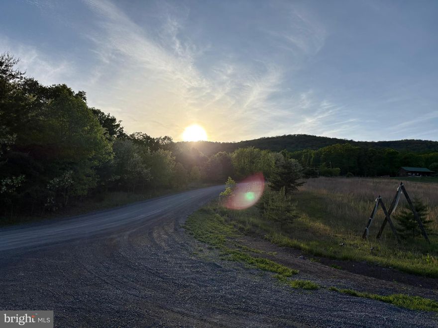 Here is your chance to own a prime building lot in a beautiful location with mountain views in all directions. Lot 55 Grimaldi Way is located in the Crescent Orchard Community of Hedgesville, WV. You will enjoy this quiet private neighborhood, with breathtaking views, ready for you to bring your builder. Perc test with certification letter and current survey recorded plat on file with county. All of the neighborhood has large sized lots which are 5 acres or larger.  HOA for road maintenance, snow removal, maintain common areas, etc. more info available.   This neighborhood has common areas, a pond stocked with fish, gazebo, picnic tables, and direct access to Sleepy Creek Wildlife Management Area with over 28,000 acres on which to hike, hunt, fish, and camp.   This lot and community is private, yet just 30 minutes to Martinsburg, 20 minutes to Inwood, 35 minutes to Winchester, VA, and 40 minutes to Hagerstown, MD. This one will go fast, schedule your showing today.
