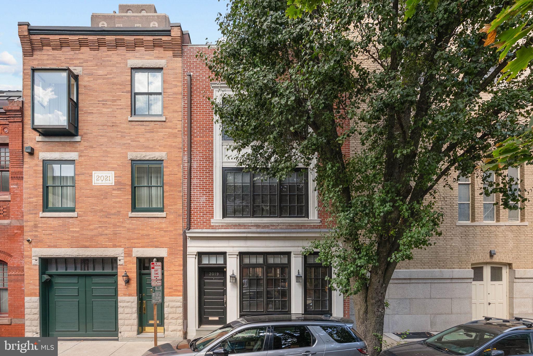 A coveted location, only steps from the park, exquisite architectural details, abundant space, and modern updates make 2019 Rittenhouse Sq an enticing choice for the discerning buyer. Spanning an 80ft deep, street-to-street lot, this 3,000 sqft (per matterport) home offers 3 bedrooms and 3.5 bathrooms, each suite with its own private wing, and a serene terrace off the third level acting as an escape from the city's hustle. A quiet, tree-lined block leads to the residence's impressive brick and concrete facade. Stepping inside, you're welcomed by a foyer with a coat closet. Gleaming hardwood floors extend to a large, airy living room where tall windows pour in natural light and crown molding traces the soaring ceilings. Adding to the timeless character is wainscoting on the walls and a fireplace mantel flanked by built-ins. At the center of the home is a commanding spiral staircase topped by a skylight, allowing more natural light. Past a powder room, the formal dining room has plenty of space for entertaining and more detailed millwork. Many memories and comforting meals are sure to be made in the magazine-worthy chef's kitchen, boasting custom wood cabinetry, high-end stainless steel appliances, natural stone countertops, a subway tile backsplash, backlit tray ceilings, and an island with seating and pendant lights overhead. There's also a sunlit breakfast nook and a pantry by the back door. Up on the home's second level, the hotel-like primary suite is off the stairs. It's composed of a large, bright bedroom, a walk-in closet, and a luxurious ensuite bathroom adorned with rich marble tile, a double vanity, a glass-enclosed shower, and a multi-jet soaking tub. Sitting opposite the primary suite is another full bathroom, a spacious bedroom, and the laundry closet. The third level has the final bedroom suite with a similar layout. There's also a bonus den with a wet bar and access to the terrace, perfect for hosting friends and family. Inside, you can gather around the fireplace mantel for a cozy night in, while outside, you can enjoy summer barbecues and al fresco dining. Completing the home is an expansive basement with tons of extra storage. In addition to everything inside, 2019 Rittenhouse Square's unbeatable location earns a near-perfect Walk Score of 98! The city's best dining, shopping, and entertainment are all at your doorstep. Sprawling Rittenhouse Square Park is only a block away, and the extensive Schuylkill River Trail is close. Plus, there's easy access to the University of Penn, Jefferson Hospital & Pennsylvania Hospital, and I-76. Schedule your tour today!