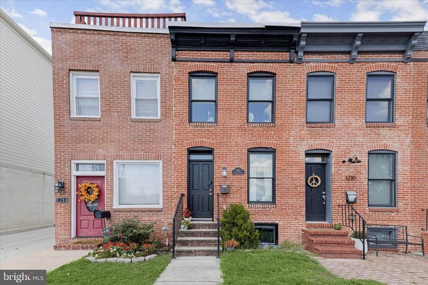 Introducing this beautifully updated CHAP rowhome in Locust Point, offering three bedrooms and three full bathrooms across three thoughtfully designed levels. A private parking pad, ample street parking, and a rooftop deck with 360-degree city views elevate everyday living. Inside, a neutral palette, recessed lighting, and engineered wood flooring create a warm and inviting atmosphere throughout. Crown molding and an exposed brick accent wall frame the front living room, while the open-concept layout seamlessly connects the dining area and kitchen. Featuring stainless steel appliances, granite countertops, shaker-style soft-close cabinetry, and a breakfast bar with pendant lighting, the kitchen is both stylish and functional. Upstairs, the primary suite offers direct rooftop access and a luxurious private bath with a frameless walk-in shower with bench seating and a dual-sink vanity. A second bedroom and full bathroom complete this level. The finished lower level extends the living space with a third bedroom, an additional full bathroom, and a utility room with laundry. Enjoy the best of city living in vibrant Locust Point, close to local parks, shops, dining, entertainment, and more. Approximately three years remain on the CHAP credit (buyer to verify). Some images have been virtually staged.