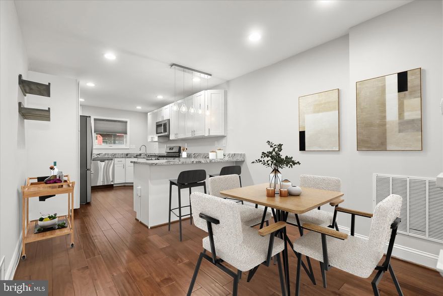 Introducing this beautifully updated CHAP rowhome in Locust Point, offering three bedrooms and three full bathrooms across three thoughtfully designed levels. A private parking pad, ample street parking, and a rooftop deck with 360-degree city views elevate everyday living. Inside, a neutral palette, recessed lighting, and engineered wood flooring create a warm and inviting atmosphere throughout. Crown molding and an exposed brick accent wall frame the front living room, while the open-concept layout seamlessly connects the dining area and kitchen. Featuring stainless steel appliances, granite countertops, shaker-style soft-close cabinetry, and a breakfast bar with pendant lighting, the kitchen is both stylish and functional. Upstairs, the primary suite offers direct rooftop access and a luxurious private bath with a frameless walk-in shower with bench seating and a dual-sink vanity. A second bedroom and full bathroom complete this level. The finished lower level extends the living space with a third bedroom, an additional full bathroom, and a utility room with laundry. Enjoy the best of city living in vibrant Locust Point, close to local parks, shops, dining, entertainment, and more. Approximately three years remain on the CHAP credit (buyer to verify.) Some images have been virtually staged.