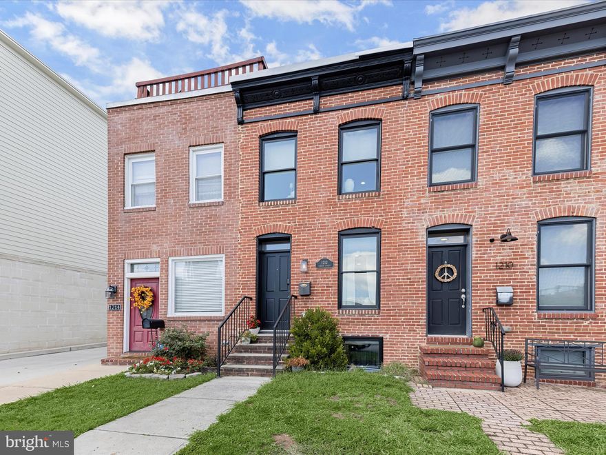 Introducing this beautifully updated rowhome in Locust Point, offering three bedrooms and three full bathrooms across three thoughtfully designed levels. A private parking pad, ample street parking, and a rooftop deck with 360-degree city views elevate everyday living. Inside, a neutral color palette, recessed lighting, and engineered wood flooring create a warm and inviting atmosphere throughout. Crown molding and an exposed brick accent wall highlight the front living room, while the open-concept layout seamlessly connects the dining area and kitchen. Featuring stainless steel appliances, granite countertops, shaker-style soft-close cabinetry, and a breakfast bar with pendant lighting, the kitchen is both stylish and functional. Upstairs, the primary bedroom suite has direct access to the rooftop deck along with a luxurious private bathroom boasting a frameless walk-in shower with bench seating and a dual sink vanity. A second bedroom and another full bathroom complete this level. The finished lower level extends the living space with a third bedroom, an additional full bathroom, and a utility room with laundry. Enjoy the best of city living located in the vibrant Locust Point neighborhood with local parks, shops, dining, entertainment options and so much more. Additionally, there are three years left on a CHAP credit. Some images have been virtually staged.