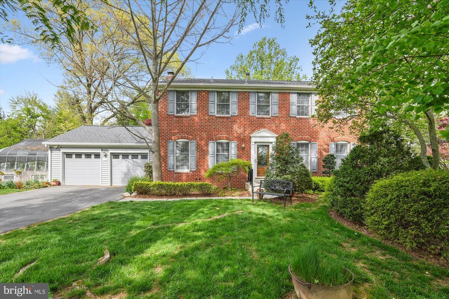 Welcome to 14612 Carona Drive, a gracious and classic colonial in a spectacular garden setting that has been meaningfully and thoughtfully updated to promote ease of living in the sought-after Naples Manor neighborhood. Special features include a new roof (2025), refinished hardwood flooring and new laminate plank on the main level (2025), professional new paint throughout (2025), new carpet on the upper level and stairs (2025), new HVAC system to serve the addition (2025), duct cleaning (2025),  and recent hot water heater (2020). The main level includes the foyer, living room, separate dining room, sunroom/bedroom addition with three exposures, skylights, vaulted ceilings, an en suite bath and views to the garden, spacious kitchen with peninsula and double-sided cabinetry, separate pantry, breakfast room, and a family room with wood-burning fireplace and a walk-out to the composite deck with swing overlooking the fenced backyard which has exquisite blooms, mature trees providing shade, and a separate tool shed. The upper level has a primary bedroom suite with walk-in closet, three additional bedrooms, a hall bath, and linen closet.  Downstairs on the lower level is a bonus room/6th bedroom, a full bath, large storage/utility room with work space, and laundry. Below the addition is a bonus store room which is accessed from the backyard. The home also features an expansive two car garage, plenty of parking in the driveway as well as a real working greenhouse that is accessed through the garage and from outside. There is a community playground and optional membership at Stonegate Swim Club in the neighborhood.