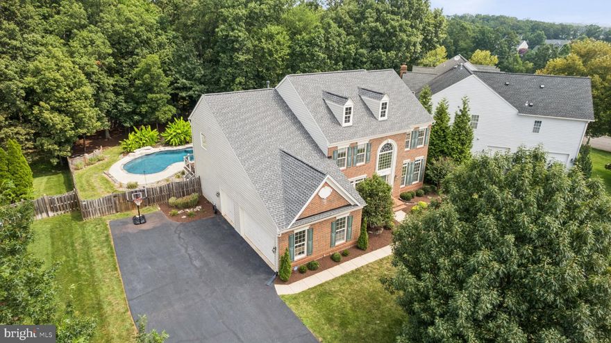 Welcome to 42762 Forest Crest Ct – A Luxury Retreat in the Heart of Ashburn

Discover your dream home in this stunning 4-bedroom, 4 full and 2 half-bath residence offering over 5,000 square feet of impeccably maintained living space on three finished levels. Nestled on a ​.46 acre lot​. This exquisite home boasts a 3-car side-load garage and a resort-style backyard that’s truly one of a kind.

Step inside to a grand 2-story foyer, flanked by a formal dining room with elegant wainscoting and two versatile rooms with French doors—perfect as offices, a library, or playrooms. The beautiful hardwood floors lead you to a spacious family room, a gas fireplace, and a striking stone mantel​.

The gourmet kitchen​ is a chef’s dream—featuring quartz countertops,​ a large center island, and  GE Profile stainless steel appliances. Open to the breakfast room and family room, it’s the perfect hub for entertaining or family living.

Step outside to a screened-in porch with a TV, a ​trex deck, and a stone patio overlooking a fenced-in, tree-lined yard. The showstopper is the saltwater pool with waterfall, surrounded by beautifully landscaped grounds with multiple seating areas, a fire pit, a picnic spot, and a game-ready lower lawn with horseshoes and space for bocce ball.

Upstairs, the luxurious primary suite offers two walk-in closets and a spa-like bathroom (renovated in 2022) with a standalone soaking tub, dual vanities, a walk-in shower, and a private water closet. Two additional renovated bathrooms serve the secondary bedrooms—one en-suite and one shared.

The fully finished lower level includes a spacious rec room with a wet bar with custom concrete countertops, and an exercise room.  There is a walk up access to the backyard. A full bath, large storage room, and additional closets complete this level.