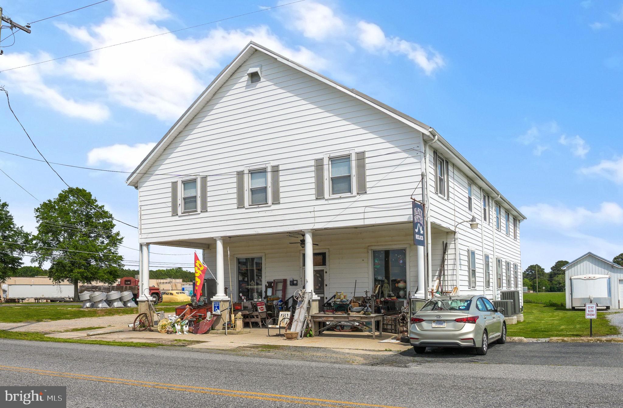 Discover a remarkable commercial opportunity in Pocomoke City at the corner of Old Virginia Rd and Market St. This spacious over 5,300 sq ft building has been extensively revitalized with new wiring and plumbing, blending durability with potential. Its sturdy construction and versatile layout open the door to a variety of uses—from an antique store to a convenience store, body shop, salon, or even a multi-unit dwelling.
The property features a charming second-story apartment with three bedrooms and one bathroom, ideal for onsite living or rental income. Additionally, a large storage area can be transformed into another apartment or workspace, offering even more possibilities. Situated on a sizeable corner lot included in the sale, this property boasts significant development potential and would be a valuable addition to any investment or business portfolio. The antique business could convey in a separate transaction.