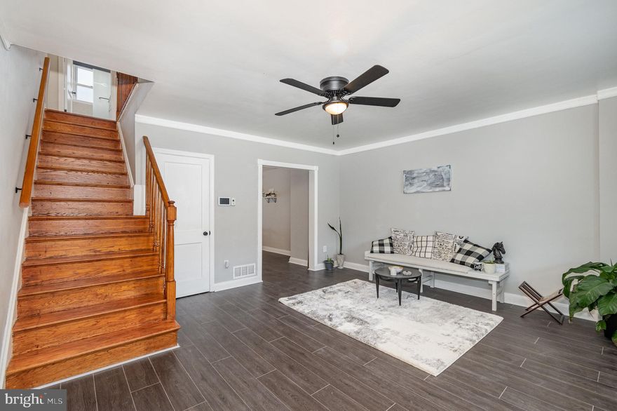 Recently updated interior rowhouse in Middle River's Hawthorne neighborhood, featuring practical upgrades, solid amenities & rear parking pad. The house has three bedrooms upstairs, all with ceiling fans and original hardwood floors for a classic touch.  A full bath is also on the upper level. On the main floor, you'll find a spacious living room, dining area, and an open kitchen equipped with stainless steel appliances and new luxury vinyl plank flooring, making it both attractive and easy to clean.  Additional ceiling fans are also on this level. The lower level is fully finished and includes a second full bathroom, making it functional as a recreational space or a fourth bedroom, complete with durable ceramic tile flooring. This extra space is versatile for any need, whether it’s extra living space, a game room, or a home office. Outside, the house includes a covered front porch and a covered patio at the back, plus a driveway for convenient off-street parking. This home is close to local shops and has easy access to major roads making it a very convenient location.