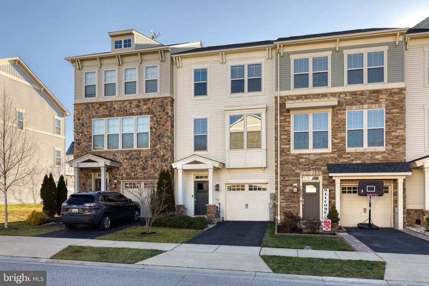 Live in luxury in the incredible Tanyard Cove North community.  This gorgeous 1 car garage townhome has been freshly painted a neutral grey tone to please anyone's design style.  The first level has a half bath and giant open space for a rec room/game room/ gym/or family room space.  The possibilities are endless.  There is even a walk out to the fenced backyard!   The next level of the home has a separate living room space that opens up to the expansive kitchen and dining area.  The kitchen is truly a chef's dream with an elongated center island, miles of cabinet and counter space, stainless steel appliances, granite counters, and custom built ins for added pantry space, wine storage, and even a beverage fridge.  There is even space for coffee nook! Enjoy relaxing in your primary suite with a private bathroom and lots of closet space.  The additional 2 bedrooms are spacious with great closet space.  There is a deck that is begging for a summer BBQ.  Community amenities include: pool, tot lot, fitness center, water privileges, and community center!