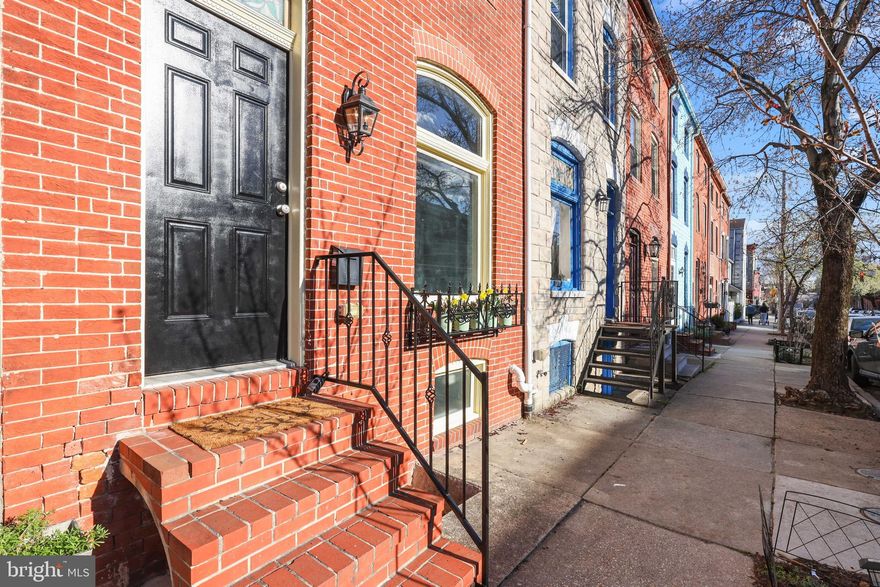 This brick front Fells Point beauty offers an impressive amount of space and blends the best of form and function.  The extra-large living room is anchored  by hardwood flooring and counters nicely with an exposed brick wall that is home to two fireplaces (1 decorative).  The gourmet style kitchen with granite counters, stainless appliances and lovely  tile backsplash opens to a sizable dining area; which make hosting your celebrations or  holiday dinner a breeze.    Enjoy weekends spending time outside on your charming brick patio with built-in planters. Yes! You can finally let that inner gardener shine!  The second level houses two LARGE bedrooms. The primary bedroom has a custom walk in closet and  en-suite and the second bedroom offers a large walk-in closet and  easy access to a stunning hall bath.  The third level offers bedroom #3 complete with a walk-in closet, vaulted and beamed ceilings, an additional beautiful bath and an exit to your brand new roof top deck where you'll enjoy stunning views of the city.  And finally, the lower level mimics the size of the living room with the space you'll need for that game day watch party.  Minutes from downtown, Hopkins, and the Fells Point waterfront.  This stunner does not disappoint!  Seller has requested an OFFER DEADLINE of Wednesday  April 6th at 6pm.