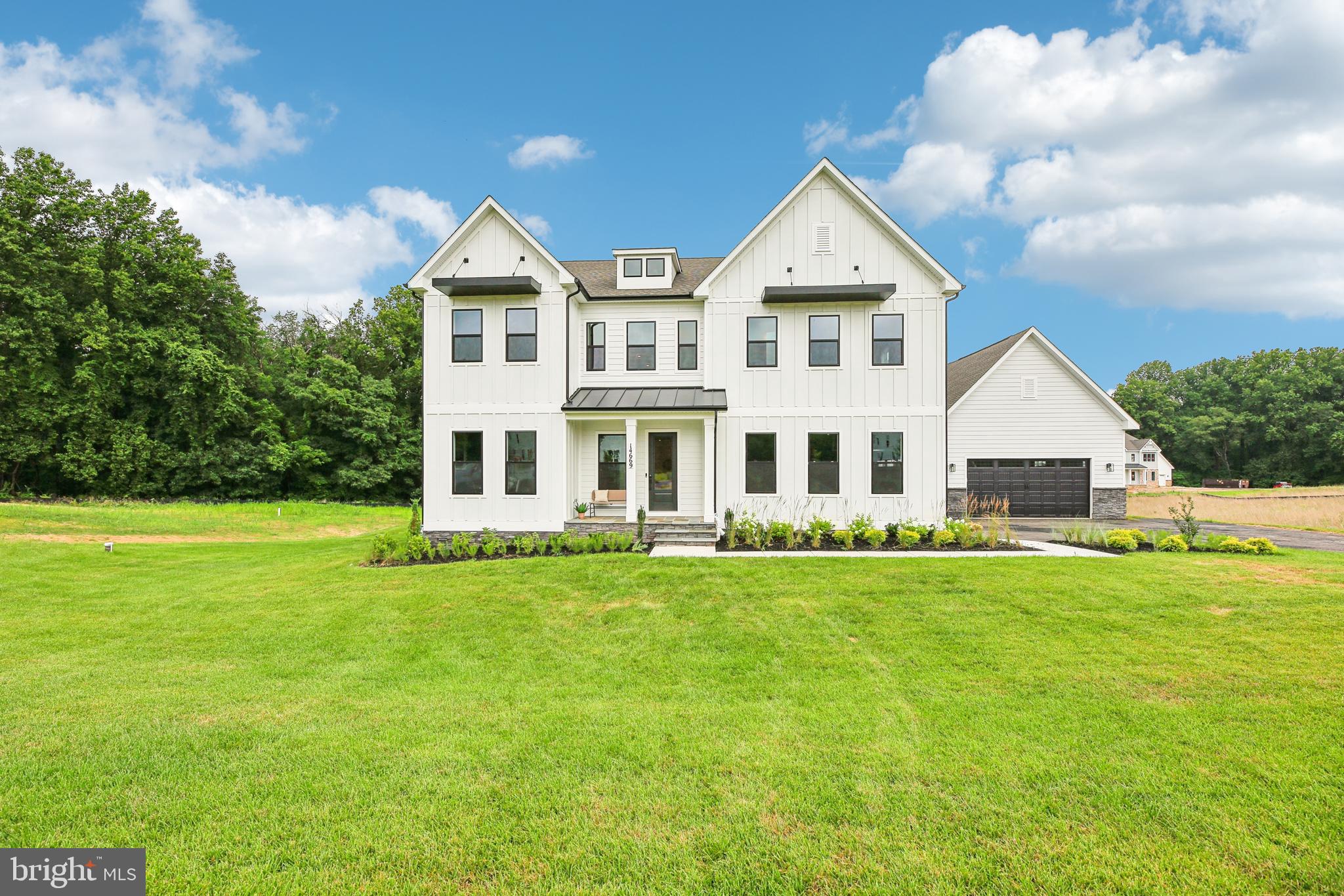Must close by September 2025. Ask About our financing incentives! Meet the Hampton II model home which includes 6 bedrooms/6.5 baths with a 4-car garage and sits on a very private 1.5 acre homesite and backs to conservation area. Enter this home from a covered porch and view the soaring 2-story foyer. A flex room with French doors greets the entrance for use as you prefer- a home office or formal living room. The formal dining room is off the foyer and includes tray ceilings. Tray ceilings are additionally included in the family room and kitchen area. The kitchen and great room share the ever-desired open concept feel. Stay cozy near the contemporary linear fireplace and enjoy picturesque views from the double sliding glass doors. A conservatory is just off the family room. - perfect for holiday entertaining. The kitchen is complete with Aristokraft soft-close cabinets with below cabinet lighting and quartz counters. Fit for a chef this kitchen includes high-end KitchenAid gourmet appliances with a 36” gas cooktop, double oven or microwave/oven combo, double oven, dishwasher and French door refrigerator. 10 Foot ceilings are throughout the main level with 9-foot doors giving a airy feel throughout. The owner entry is positioned nearby and includes a drop zone. A private first floor bedroom is tucked away with walk-in closet as well as a main level full bath with walk-in shower. The solarium is off the family room providing gorgeous, wooded views. Oak stairs with iron balustrade led to the bedroom level. The primary is at the top of the staircase and is finished with a bedroom and sitting area with tray ceilings. Enter the primary bath through a generous hall through French doors. This bathroom will take your breath away! A walk-through glass front shower is the focus of this bath with double shower heads and a free-standing tub in front. Separate vanities provide plenty of storage with soft-close cabinets and quartz counter tops. A water closet is off to the side. Two generous walk-in closets are in this bedroom. Mohawk Revwood floors are featured in the hallway. For convenience, the laundry room is on the bedroom level which includes cabinets and a utility sink. Storage is abundant with two linen closets. All secondary bedrooms are generously sized and include a bath and walk-in closet. Secondary baths finished with 6x6 ceramic tile, soft-close cabinets and quartz counters. The basement is complete with a recreation room, full bath and basement bar. A video doorbell, Echo Dot, Zwave thermostat and door lock and wi-fi enabled garage door openers. July 2025 closing. *Photos not of actual home, and are of a similar model*