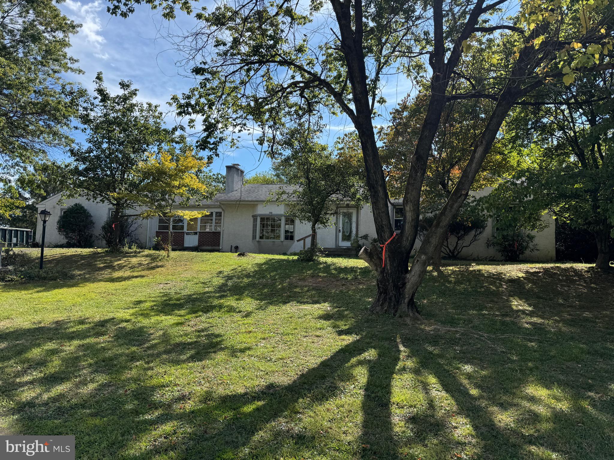 This unique five-bedroom, three-bathroom ranch-style home rests on 1.74 Acres in Lower Gwynedd, Township. Lot dimensions are 214 feet in width and 354 feet in depth. The exterior is entirely clad in stucco and complimented by a sunny Bay window. Inside, you’ll find a cozy fireplace and Hardwood flooring traverses the hallway and all of the bedrooms. Upgrades include newer windows, central air conditioning, an updated heating system, and 200 amp electrical service. While the interior is in need of updating the home remains fully operational so you can easily live there while working on it. The location is close to a long list of restaurants and shopping and as an extra bonus you are in the Award Winning Wissahickon School District. Don't miss the excellent opportunity to gain some some sweat equity and make this house your home!