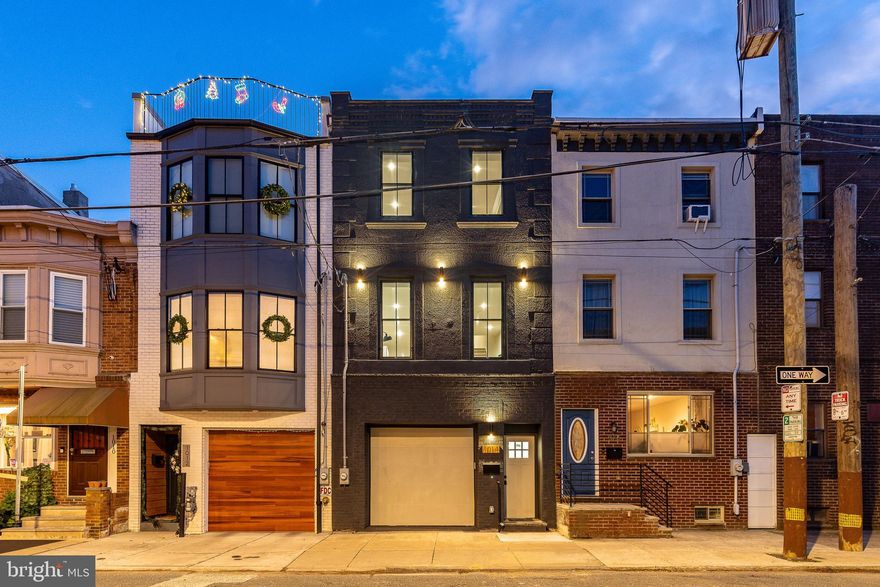 OFFER DEADLINE set for Tuesday 1/13 at 12pm. We have received strong interest in the property and are asking interested groups to submit their Best & Final offers by 12pm Tuesday 1/13. Located on a premier block in Passyunk Square, this fully renovated single family home offers one of Philadelphia’s most sought after features: two car garage parking. 1014 Ellsworth Street is a 17-foot-wide residence spanning approximately 2,654 square feet, featuring 3 bedrooms and 3.5 baths. The home is filled with natural light, accented with brand-new Pella windows throughout, including massive southern facing picture windows overlooking the dining area. A portion of the dining space is vaulted and features soaring 18-foot ceilings, creating a bright and inviting setting ideal for entertaining and everyday living. A convenient powder room is located just off the dining area. The chef’s kitchen is a true showpiece, offering a 14-foot custom waterfall island, GE Café appliance package, oversized farmhouse sink, custom wood range hood and ceiling beam, and abundant Fabuwood cabinetry with a spacious pantry. Just off the kitchen is an open and inviting living room, perfectly suited for entertaining. A second set of stairs in the rear leads to the above grade finished space beyond the garage and features striking 24x24 checkered tile and a beautifully appointed full bathroom. A fully expandable accordion glass door opens directly to the private rear yard, finished with modern pavers and turf—ideal for entertaining, play, or relaxation. Above, a full roof deck with Endurit roofing (with warranty) provides additional outdoor living space with sweeping views of Philadelphia. The primary suite is a true retreat, highlighted by custom wood paneling and crown molding, along with a large dual-sided custom walk-in closet that seamlessly connects to the spa-like primary bathroom. Two additional generously sized bedrooms feature custom trim details and spacious double closets, offering exceptional storage rarely found in city homes. This level also includes a chic shared bathroom and a stackable GE Laundry Center. Additional features include brand new HVAC, wiring and plumbing throughout, plus numerous high-end finishes. The property also benefits from an approved 10-year Rehab Tax Abatement (Ord. 961), providing substantial long-term tax savings for the full 10-year period. Located in the coveted Jackson Coppin School Catchment, this home presents a rare opportunity to own a design forward oasis with two car parking in one of Philadelphia’s most vibrant neighborhoods—just steps from acclaimed dining, boutique shopping, and community charm. Schedule your showing today—this exceptional home will not last! Member of owning LLC is a licensed Realtor in Pennsylvania.