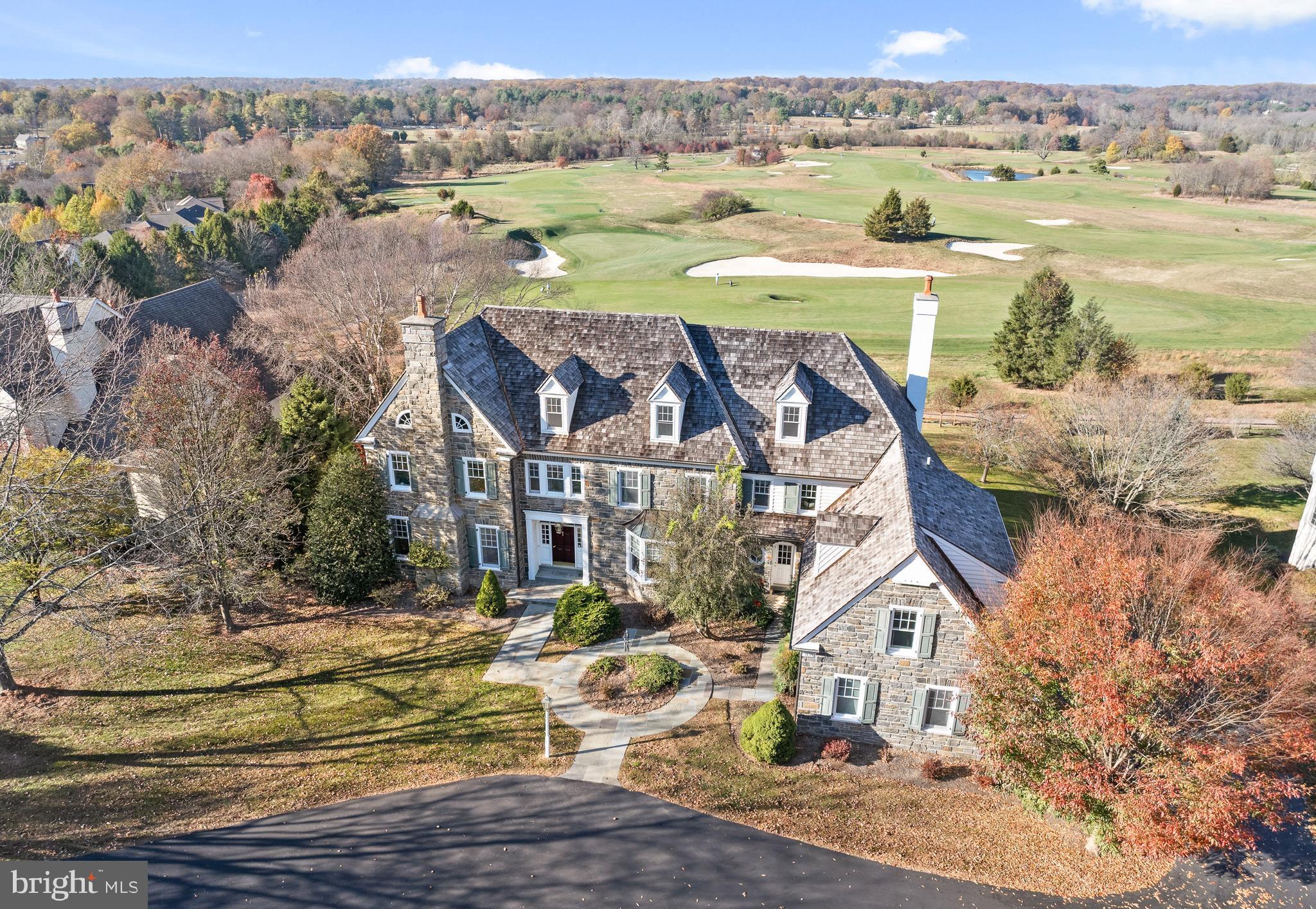 Stunning stone colonial with unobstructed views overlooking Applebrook Golf Club’s 3rd hole! This custom-built home offers an elegant, versatile interior with custom millwork, luxurious finishes and breathtaking outdoor spaces with specimen plantings and a covered patio with picturesque views making it perfect for entertaining and everyday living! Enter the grand foyer and the tall ceilings, large windows, custom moldings, eye-catching staircase, and an abundance of natural light will impress. The hardwoods and elegant molding span the first level through the formal living room with gas fireplace and spacious dining room, both off of the foyer. The kitchen is a chef’s dream with a large seated island, high-end appliances, granite counters, custom outfitted walk-in pantry, and custom cabinetry, open to the breakfast room surrounded by windows and overlooking the golf course, perfect for morning coffee. A 5-burner Thermador gas range with double wall oven, Sub Zero Refrigerator and paneled dishwasher make cooking in this kitchen anything but a chore! A wet bar with glass cabinets and a beverage fridge overlooks the family room. A butler's pantry offering additional storage leads to the large formal dining room. The kitchen and breakfast room are open to the light-filled great room that features a gas fireplace with a paneled surround, built-in bookcases, and a coffered ceiling. The home office is tucked away off of the main hallway, allowing for privacy and a quiet space to work from home with french doors opening to a covered patio with stunning views. A formal powder room, back staircase, oversized laundry room, a mudroom with built-ins, and a 2nd powder room are conveniently accessible to the 3-car garage and round out the first floor. The grand primary bedroom suite with a trayed ceiling is located at the top of the stairs. From the bedroom, the views are serene overlooking the golf course and park beyond, with a large bathroom and dressing area, complete with window seat, and dual custom outfitted walk-in closets this suite will delight! The sumptuous primary bath features custom cabinetry, marble counters, his/her vanities, a dressing area, a soaking tub with tile surround, and frameless glass shower and a private WC. Bedroom 2 is large with a double-door closet and features an en suite bath with neutral finishes. Bedrooms 3 & 4 are both spacious with walk-in closets and share a jack-and-jill bathroom with neutral tile, each with their own vanity room, a tub/shower combo, and a private shower/toilet room. Bedroom 5 is a large en suite room which would also make a great playroom! An office/homework station is centrally located on the upper floor and the large walk-in cedar closet completes this floor. The walk up attic is floored for excellent storage, and ready for finishing. The Walk Out Lower Level features full-sized daylight windows and high ceilings, a great room complete with a pool table and a custom wet bar with drawer dishwasher and beverage refrigerator making it a perfect space for entertaining. French doors open to a Home Gym with mirrored walls and windows and a full bath with sauna is perfect for completing a workout. A temperature/humidity controlled wine cellar, and a workroom/storage area just add to the fabulous functionality of this home! Outside the almost 1-acre lot allows for privacy and the flagstone patio offers a wonderful dining space for al fresco dining overlooking the golf course and East Goshen Park! All of this is located in award-winning West Chester Schools and convenient to major highways and transportation! ***Buyers should verify HOA info with the review of HOA docs