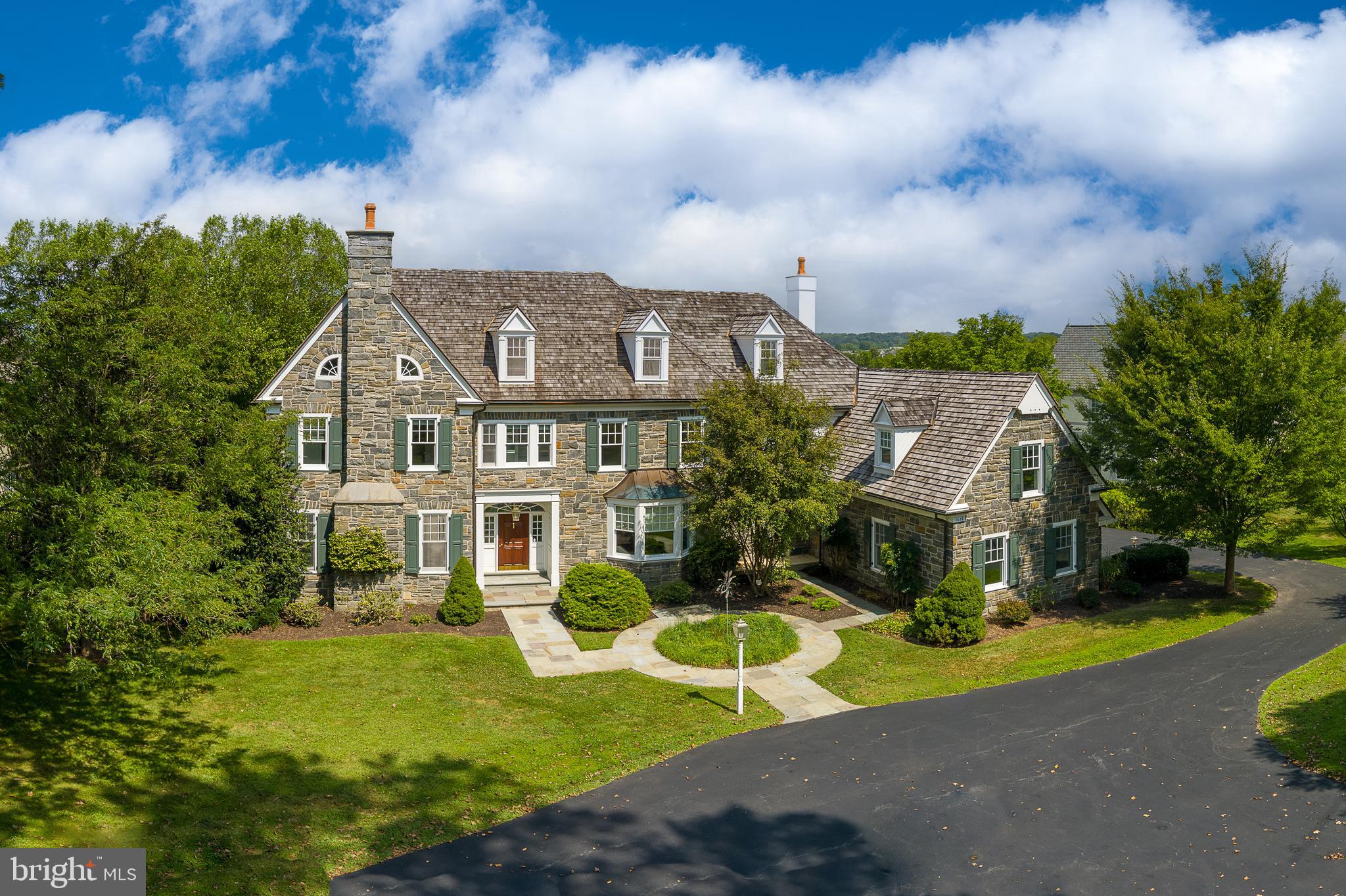 Stunning stone colonial with unobstructed views overlooking Applebrook Golf Club’s 3rd hole! This custom-built home offers an elegant, versatile interior with custom millwork, luxurious finishes and breathtaking outdoor spaces with specimen plantings and a covered patio with picturesque views making it perfect for entertaining and everyday living! Enter the grand foyer and the tall ceilings, large windows, custom moldings, eye-catching staircase, and an abundance of natural light will impress. The hardwoods and elegant molding span the first level through the formal living room with gas fireplace and spacious dining room, both off of the foyer. The kitchen is a chef’s dream with a large seated island, high-end appliances, granite counters, custom outfitted walk-in pantry, and custom cabinetry, open to the breakfast room surrounded by windows and overlooking the golf course, perfect for morning coffee. A 5-burner Thermador gas range with double wall oven, Sub Zero Refrigerator and paneled dishwasher make cooking in this kitchen anything but a chore! A wet bar with glass cabinets and a beverage fridge overlooks the family room. A butler's pantry offering additional storage leads to the large formal dining room. The kitchen and breakfast room are open to the light-filled great room that features a gas fireplace with a paneled surround, built-in bookcases, and a coffered ceiling. The home office is tucked away off of the main hallway, allowing for privacy and a quiet space to work from home with french doors opening to a covered patio with stunning views. A formal powder room, back staircase, oversized laundry room, a mudroom with built-ins, and a 2nd powder room are conveniently accessible to the 3-car garage and round out the first floor. The grand primary bedroom suite with a trayed ceiling is located at the top of the stairs. From the bedroom, the views are serene overlooking the golf course and park beyond, with a large bathroom and dressing area, complete with window seat, and dual custom outfitted walk-in closets this suite will delight! The sumptuous primary bath features custom cabinetry, marble counters, his/her vanities, a dressing area, a soaking tub with tile surround, and frameless glass shower and a private WC. Bedroom 2 is large with a double-door closet and features an en suite bath with neutral finishes. Bedrooms 3 & 4 are both spacious with walk-in closets and share a jack-and-jill bathroom with neutral tile, each with their own vanity room, a tub/shower combo, and a private shower/toilet room. Bedroom 5 is a large en suite room which would also make a great playroom! An office/homework station is centrally located on the upper floor and the large walk-in cedar closet completes this floor. The walk up attic is floored for excellent storage, and ready for finishing. The Walk Out Lower Level features full-sized daylight windows and high ceilings, a great room complete with a pool table and a custom wet bar with drawer dishwasher and beverage refrigerator making it a perfect space for entertaining. French doors open to a Home Gym with mirrored walls and windows and a full bath with sauna is perfect for completing a workout. A temperature/humidity controlled wine cellar, and a workroom/storage area just add to the fabulous functionality of this home! Outside the almost 1-acre lot allows for privacy and the flagstone patio offers a wonderful dining space for al fresco dining overlooking the golf course and East Goshen Park! All of this is located in award-winning West Chester Schools and convenient to major highways and transportation! ***Buyers should verify HOA info with the review of HOA docs