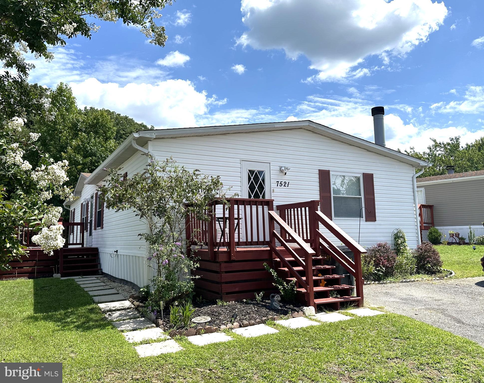 Very Nice 4 Bedroom Double Wide in Sought After Holiday Mobile Estates! Over 1700 square feet with a Large Eatin Kitchen, Lots of Cabinets, Counter Space, Island with Breakfast Bar and Luxury Vinyl Plank Flooring/. Just off the Kitchen is a Family Room with a Fireplace. You have a Separate Formal Dining Room and a Front Sitting Room. The Primary Bedroom is Nice Sized with a Private Bath, Corner Garden Soaking Tub, Separate Shower and Walkin Closet. Recent Updates Include Roof, HVAC, Windows and New Carpet Throughout. Outside is Nicely Landscaped with a Custom Front Deck and Secure Storage Shed. Community Amenities Include Several Tot Lots and a Basketball Court. Close to Schools, Shopping and Restaurants. Minutes to Ft Meade and Arundel Mills Mall. Don't Delay!