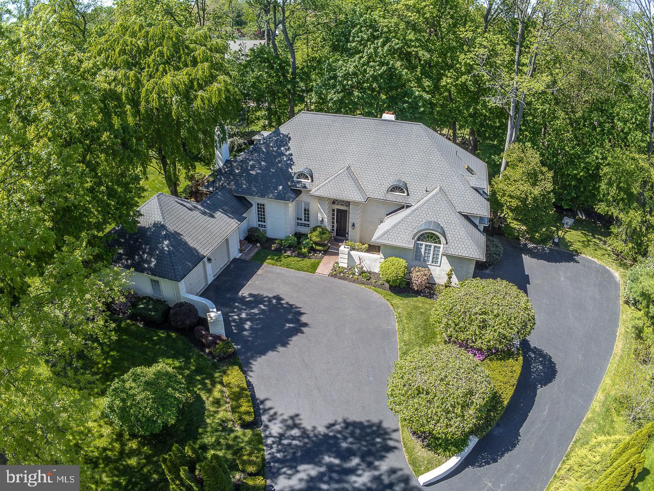 Beautiful light filled spacious updated French Colonial located in the estate section of Haverford situated at the end of a lovely cul de sac; this home was specially built by the Builder as his own residence on the perfect lot with great attention to amenities and details. Dramatic two story Foyer, with very attractive floating staircase, and stunning stone floor. Gracious Living Room with marble surround wood burning fireplace; Formal Dining Room with Hardwood Floors; Updated Cooks delight Kitchen, 5 burner Gas cooktop, double oven, Hardwood Floors, Breakfast area; Sliding glass doors to a large and private Deck, perfect for outdoor entertaining, Deck overlooks tranquil professionally landscaped flat yard, with a delightful Fire Pit for year round enjoyment. Inviting Family Room located off the kitchen, vaulted ceilings, wood fireplace, and arched windows complete this room. Wet Bar, First floor Laundry Room/Mudroom, opening to an oversized 2 car garage with ideal work space for the handy home owner. Fabulous Home Office, with beautiful built-ins with desk, wood floors, large palladium window, vaulted ceilings, and separate exit to outside. Convenient first floor Master Bedroom, with sliding glass door to private Deck over looking pretty greenery, Hardwood Floors, two walk in closets, delux master bath with marble floors, large soaking tub, double sink vanity, and separate shower room with marble shower. Powder room. Second floor has 4 spacious Bedrooms, two full baths, walk in closets, and an open Sitting Area overlooking 1st floor Family room, Sitting Area includes a second laundry station. Very spacious walkout Lower Level with easy access to the outside through sliding glass doors, large finished Recreation Room with a second kitchen, full bath, large storage are with workout area, and third Laundry station. Lower Level has access to an additional 2+ car attached garage. New mechanicals including A/C, gas boiler and water heater complete this turn-key property. Ideally located within walking distance to 2 train lines, connecting to Center City and Western Suburbs; Village of Haverford, great walking trails/nature trails, easy access to biking routes; located close to Haverford Station, Schools, great Suburban Square stores, and Merion Golf Club. Nearby is the Community Recreational and Environmental Center (CREC) where residents can enjoy open space, hiking trails, athletic complex and both indoor and outdoor recreation and athletic facilities. THIS HOUSE HAS IT ALL AND WILL BE LOVE AT FIRST SIGHT!!