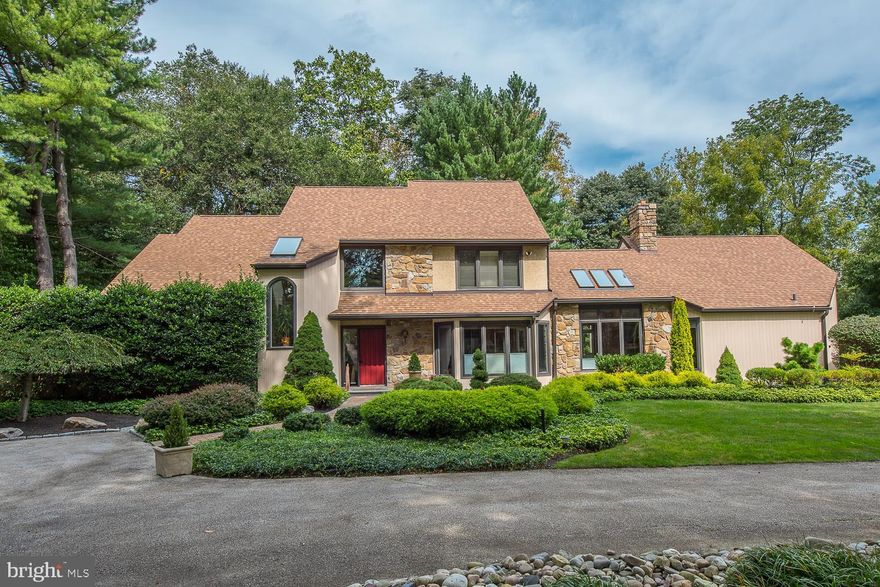 On a quiet cul-de-sac in Gladwyne, tucked behind a magnificently manicured garden, is where you will find this beautifully designed Anne Capron custom-built home. Situated on a lush, flat 1.05-acre lot, with 4 bedrooms, 3 full bathrooms, 1 powder room is 1310 Huntsman Lane. The semi-circular driveway, surround by garden beds and mature trees leads you to the grand, 2-story entryway.  The foyer opens to an expansive living room with vaulted ceiling, hardwood floors, wet bar, built-in wall unit, large windows overlooking the expansive grounds and a sliding glass door that draws the outside in. Adjacent to the living room is a formal dining room with two walls of windows and a custom designed buffet. The dining room leads to the kitchen creating the perfect flow for entertaining. The eat-in, chef's kitchen includes a large center island with 4-burner gas cooktop, stainless steel appliances, Advantium microwave-oven combination, a built in desk, tile flooring, and ample counter/cabinet space. The breakfast nook, which overlooks the front yard through a floor to ceiling bay window, can accommodate a table for 6 or more. The cozy family room includes a vaulted ceiling with skylights, a gas-burning fireplace with stone surround, built-in cabinets and a sliding glass door that leads to the stone patio. Behind a custom built, etched glass door is where you will find the first floor master bedroom retreat.  The master includes tons of natural light, wall-to-wall carpeting and ample closet space with mirrored sliding doors.  The renovated ensuite bathroom has skylights that allow natural light to stream in, a new Jacuzzi tub, vanity, glass enclosed shower and water closet. A large mudroom with access to the 2-car garage, laundry area with ample closet space, a powder room and coat closet complete the first floor. Ascend the stairs to the second story landing, which over looks both the foyer and living room. The second floor includes 3 sun-lit, spacious bedrooms, one with an ensuite bathroom and a shared Jack-n-Jill bathroom, and an exercise room/office. The finished lower level is the perfect space for a playroom or second family room with wall-to-wall carpeting and tons of storage. The lush, flat backyard includes a large deck and patio ideal for entertaining. This backyard oasis feels like your very own park.  Some of this home's wonderful features include a newer roof (2012), full house generator, a 9-zone irrigation system, new heater/AC unit with variable speed fan, new kitchen appliances and Pella windows. This home is centrally located minutes away from Center City Philadelphia, restaurants, shopping, parks, walking trails and so much more! All this and in the award-winning Lower Merion School District.