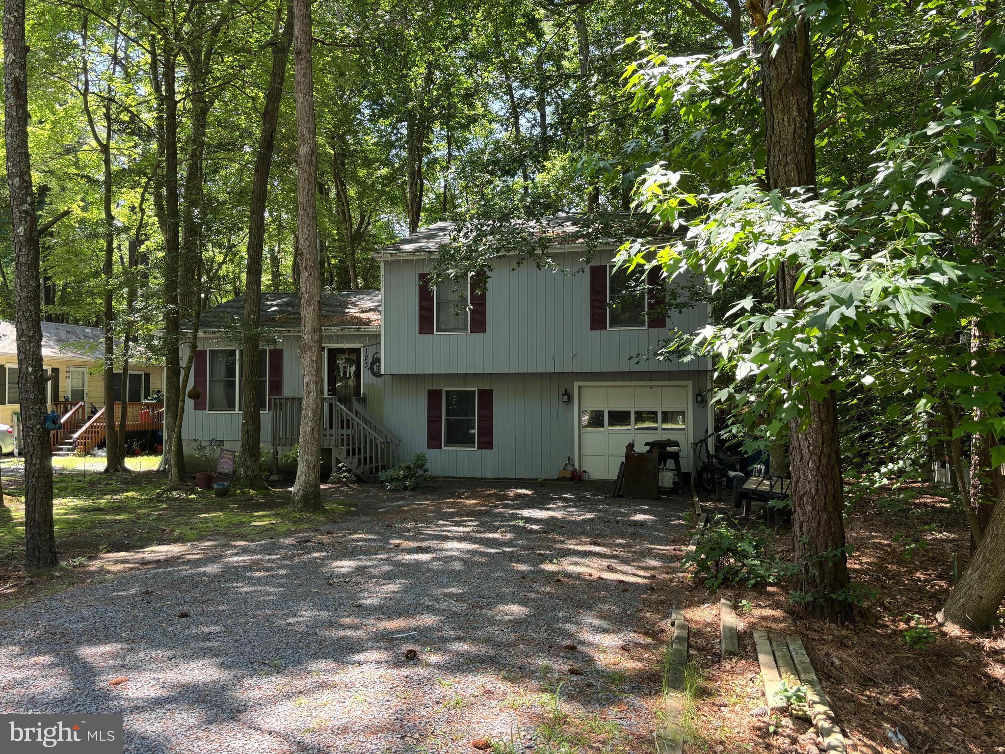 Spacious 3 bedroom, 3 bath raised rancher with a garage. There is a screen porch overlooking the private wooded yard. The HVAC was replaced in 2021 and roof in 2022. The lower level offers a generous family/flex room with full bath. Close to beaches and all that Ocean City has to offer. Short distance to community golf, swim, racquet and yacht club.