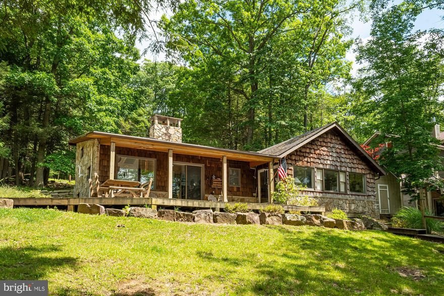 If you are looking for breathtaking lakefront with gorgeous sunsets at Deep Creek Lake and a home with endless possibilities, this is it! This stone cottage feels warm and inviting from the moment you walk in. Offering an abundance of windows to allow you to enjoy the beauty of the views during any season. Boasting 3 bedrooms and 3 full baths,  it has three levels of space and a detached garage. The sellers have already taken the time to have an architect draw up a complete renovation for this home.  If you are looking for a Deep Creek Lake vintage cabin or a home and property to convert to your dream lake home, this checks off all the boxes. The detached garage has an upper level that can be converted into an apartment. The 100' of lakefront and Type A dock are just a few more great features this home has to offer. The location is just one more plus, just minutes to Wisp Ski Resort. Call today to preview, this gem won't last long!