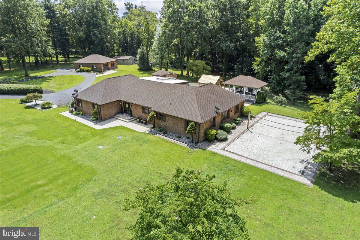 Welcome to your private resort retreat!
This stunning 5-bedroom, 3-bath estate sits on nearly 5 acres and offers the perfect blend of luxury, comfort, and recreation—all in a prime location with easy access to VA and DC.
Inside, you’ll find a freshly painted interior featuring a spacious kitchen with an oversized center island, an expansive living/dining area, cozy fireplace, and generously sized bedrooms designed for ultimate comfort.
Step outside to your own backyard paradise: a bright Florida room leads to a sparkling saltwater pool with a brand-new vinyl liner, a massive pool house with a bathroom, and a granite bar pavilion with a step-down deck—perfect for unforgettable entertaining. A professional-size volleyball court adds even more fun, while thoughtful updates—including a new roof, a new septic system (2023), and a well-maintained HVAC—offer peace of mind.
Just a short walk from the main home, you’ll find a private in-law suite complete with a full kitchen, living room, bathroom, and oversized bedroom—ideal for extended family, guests, or rental income.
✨ Don’t miss this rare opportunity to own a true lifestyle property!