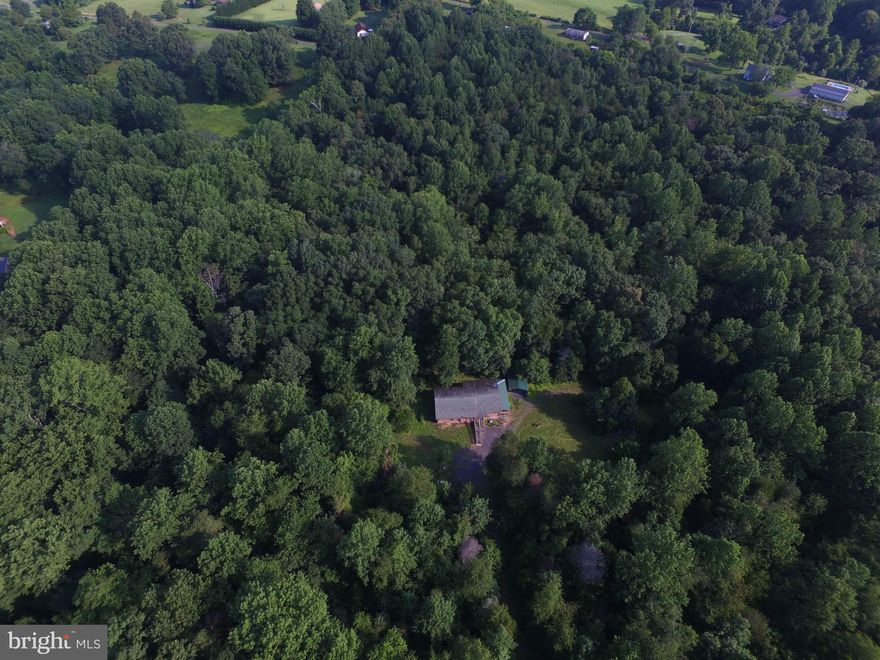 A retreat not far from downtown Culpeper with so much potential. 32.89 private acres that can be utilized for your dream home with divisible acreage for extended family ,an Air BNB rental, or acreage for a developer. Well kept, spacious, still smells like new cedar wood log cabin ( approx. 1635 sq.ft ) built in 2002  is located on property with private well/septic. 3 bedrooms, 1 half bath with shower,  and 1 full bath in master bedroom with motion light, walk-in closet.  Light oak cabinets in kitchen awaiting new appliances, high ceilings, side wrap around deck, customized light fixtures, ceiling fans, loft in 2 rooms, enclosed glass window back porch with a 4 person Jacuzzi hot tub in good condition, and most of all PRIVACY!! New water heater installed in 2009, heating stove installed that will heat the whole cabin done in 2009. Basement approx. 24ft x 40ft and well insulated. Carport. Propane tank above ground (est. 150 gal.).  2 separate parcels sold collectively 40-156 (26.6 acres), 40/157 (6.29 acres).  A well has been installed for cattle.