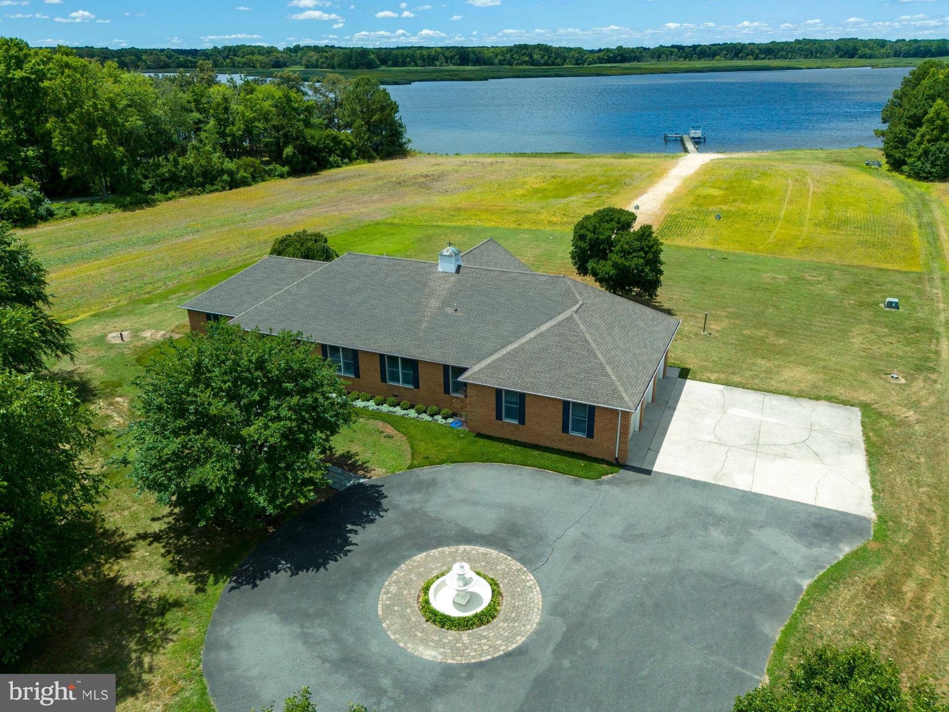 Waterfront retreat with broad westerly views across the Choptank River - the canvas of this remarkable view is touched by vibrant wetlands and preserved farms teaming with wildlife and waterfowl. A paved, tree-lined driveway provides a handsome entry to this lovely nine-acre waterfront retreat located a short drive from Easton (8 miles) or Preston (6 miles). The brick rambler was built in 2001 and has been dutifully maintained and updated. The orientation of the house is westerly, capturing the river views with a large water-side screened porch where one may appreciate the noteworthy sights and sounds. The floor plan of the house lends itself to entertaining with an open-concept kitchen with island including a Gaggenau steamer. Beautifully refinished oak floors create warmth throughout the open-concept kitchen, dining, and living rooms, with a gas fireplace and built-ins for the entertainment console. The primary suite is on the south side of the house with water views, large closet, an accessible shower and corner bath. Off the foyer is an office / study opening to the great room. Past the kitchen are two additional bedrooms, a full bath, laundry and a spacious three-car garage. The mechanicals are located in the garage and are readily accessible. There is a propane-fired hydronic heating system serving the domestic hot water and HVAC system and the
crawlspace has been recently encapsulated. The second floor was recently refinished and serves as a recreation/studio space with a full bath. The property has five acres under cultivation with a local farmer rotating crops yearly. There are 382 feet of shoreline with improvements, including rip-rap stone revetment and a pier with over four feet of water at mean low tide. With close proximity by water to area restaurants, this property is just 15 minutes to Suicide Bridge Restaurant by water, 25 minutes to the Hyatt Chesapeake.