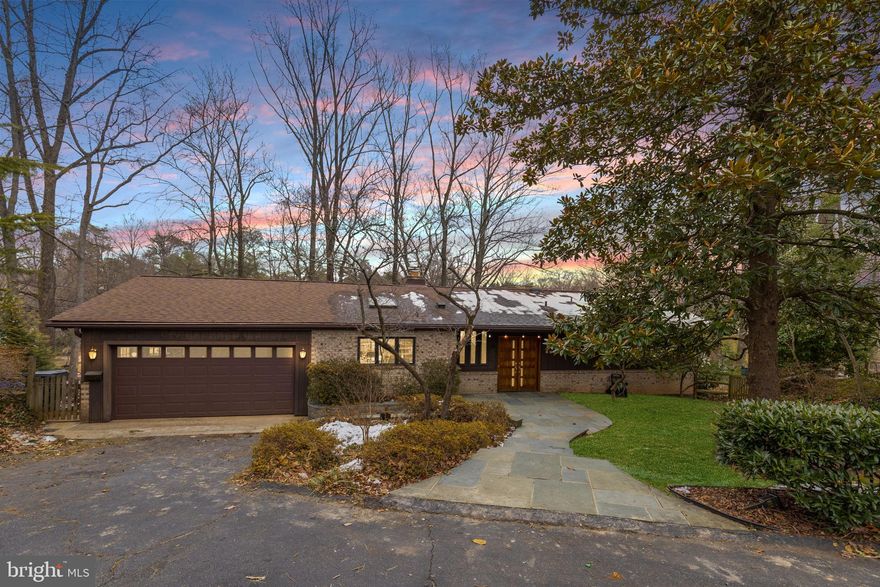 LAKE BARCROFT | WATERFRONT

With over 150 feet of pristine shoreline and sweeping lake views from nearly every room, this 4BR/3BA Mid-Century Modern home is a rare waterfront offering. Tucked among the trees on a quiet cul-de-sac and set on almost half an acre, it lives like a private retreat, perched above the water with a true treehouse feel.

A slate walk leads to double doors and into a dramatic, light-filled interior. Cathedral ceilings soar above the main living space, where a wall of glass frames the lake and brings the outdoors in. Hardwood floors, skylights, and clean contemporary lines highlight the home’s architectural character. The updated kitchen features  granite counters and a breakfast bar, and opens to the family room, creating an easy, open flow for everyday living and entertaining. A main-level bedroom and full hall bath offer flexibility for guests or office space.

Downstairs, the spacious ensuite primary suite opens directly to the lower level deck and water views beyond, and includes a private sitting/dressing area and updated bath. This level also features a recreation room with fireplace, the third bedrooms an updated hall bath, laundry, and a bonus room—ideal for hobbies, workouts, or extra storage.

Multiple decks invite you to unwind with morning coffee or sunset dinners overlooking the lake. Swim, fish, or paddle from your private dock, and enjoy landscaped grounds with mature trees and seasonal blooms. A semi-circular driveway and attached two-car garage add everyday ease.

Waterfront living, timeless mid-century design, and an unmistakable sense of calm—this is Lake Barcroft at its best.