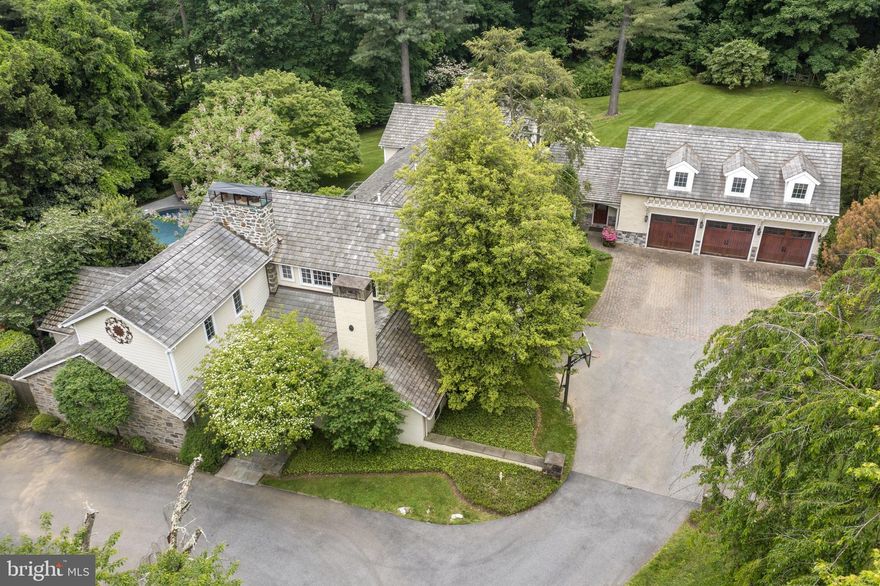Welcome to 569 County Line Rd , A  private retreat with a resort setting , tucked away from it all, but minutes from everywhere on the Main Line. This quiet property runs contiguous to the private drive, Woodland Lane. A Walter Durham classic built in 1940, with his signature details; graciously proportioned rooms , random width floors,  large windows & terrace doors opening to outdoor spaces providing for bright sunny interiors -all which have been incorporated and seamlessly expanded by Peter Bachelor to meet the needs of today’s refined buyers; flexible interior spaces , privacy,  office space, In-law /Guest Suite , Separate Apartment and gorgeous outdoor space including a Fireside Pool.
First Floor:  Entrance Hall  with Hand Forged Wrought Iron Front Door,  Formal Living Room with Fireplace with entrances to  private terrace and main patio,  expansive Dining Room and gallery with French Doors to the patio and  heated pool, Formal Powder Room, Open, Fireside  Gourmet Island Kitchen and Breakfast Room , all  with Wood-Mode 42’ inch Custom Cabinetry, Granite  countertops, 6 -Burner Thermador Gas Range  with griddle, Subzero refrigerator , 2 dishwashers, 2 pantries,  a wet bar with  built-in beverage , refrigerator & ice maker. Spectacular Post and Beam Great Room with see- through fireplace, dramatic lighting, and fabulous views of the park like property,  informal powder room , rear hallway to the  Mud Room with  stone radiant floor and  ample  closets , serves as the epicenter servicing the back & side entrances,  inside access to the 3 -car heated garage with Carriage Doors  and stairs to the apartment .
 Second Floor: Primary Suite with  Fireplace, Updated Marble  Bath with stand-alone tub, separate shower, radiant heat , barn doors, incredibly large custom walk-in closet with built-in shelving; 3  family  Bedrooms, two which share a Jack and Jill Bathroom, and an additional Bedroom with ensuite Bath and walk-in closet , a large Laundry Room with additional office  space, a balcony over-looking the patio and pool. In addition,  there is large  studio apartment over the 3 -car garage offering  versatile space with  full bath, and kitchenette. Circular driveway, slate patio, brick terrace,  heated pool with exterior fireplace, hot tub, 2 + acres,  level open yard spaces with fenced-in back yard combined with  gorgeous  perennial gardens  and heritage trees  . 
This special property meets today's evolving lifestyle standards in one of the most coveted and convenient Main Line Locations. Highly ranked educational institutions including top ranked Radnor Township school district, Train and major commuting routes to  Center City Philadelphia, Philadelphia International Airport, and the town of Wayne are all minutes away.