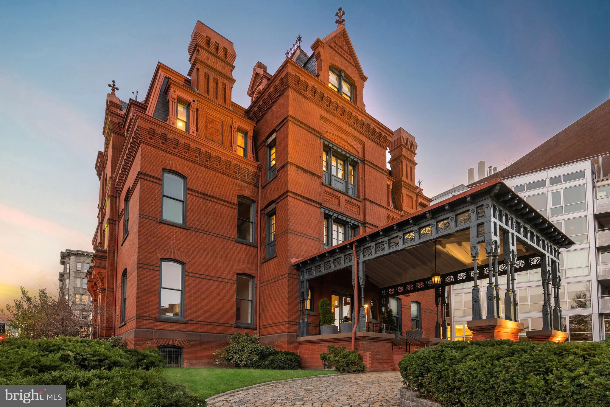 The James G. Blaine Mansion stands today as one of the most extraordinary offerings in all of Washington. A rare convergence of historical grandeur, residential elegance, and commercial versatility, it occupies a commanding position at the gateway to Embassy Row. This last-of-its-kind Gilded Age mansion comprises a 7,000-square-foot private residence atop more than 8,000 square feet of income-generating commercial office space — all within a storied structure steeped in provenance.
Showcasing a seamless blend of timeless charm and modern functionality, the Mansion was meticulously renovated from 2006 to 2009. Two floors are configured for commercial or office use, two are dedicated to luxurious residential living, and the private rooftop spans the entire fifth level. Beneath it all lies a masterfully integrated, three-story underground garage accommodating 12 parking spaces — a rare amenity in this iconic location.
Approaching via the grand porte-cochère over the original cobblestone drive offers a glimpse into the world of James G. Blaine and Washington’s high society of the 19th century. Ascending the stairs and entering through the double doors, one steps directly into history.
The first and second floors currently serve as commercial office space, featuring more than 15 private offices, two full commercial kitchens, multiple conference rooms, and two private terraces — offering an unmatched level of flexibility.
The residence, occupying the third and fourth floors, is accessed via a private elevator that opens into a double-height reception area. A paneled archway frames a dramatic rotunda, bathed in natural light from the overhead skylight. One of six fireplaces anchors the space, complemented by exquisite millwork — each detail a testament to the vision of noted Washington architect Benjamin A. Van Dusen.
Throughout the home, scale and proportion are masterfully executed. A richly appointed library with extensive built-ins, two sunlit dens overlooking Dupont Circle, and embassy-sized formal living and dining rooms create an environment that is both grand and intimate. The chef’s kitchen is warm and functional, centered by a wood-burning fireplace and built-in breakfast nook. Premium appliances from Miele, Sub-Zero, and Wolf are integrated into custom wood cabinetry, set against elegant marble countertops. Whether hosting a 40-person seated dinner or a reception for 150, the residence is designed to accommodate.
A secluded private terrace extends from the main level — partially covered for year-round use and featuring an integrated grilling station and tranquil water feature. A temperature-controlled wine cellar adds yet another layer of luxury.
The upper residential floor, framed by the original mansard roof, serves as a private sanctuary. The primary suite features vaulted ceilings, dual dressing rooms, and two spa-inspired bathrooms. Additional bedrooms with en-suite baths are complemented by a sunlit office and a fitness room complete with sauna.
Above it all, the rooftop level features a private 46-foot lap pool and outdoor kitchen, with sweeping panoramic views over Dupont Circle — a true urban oasis.
Yet beneath the refinement lies a core of advanced infrastructure: seven HVAC zones, a comprehensive security system, Sonos sound throughout, and double-pane windows — with triple-pane in the primary suite.
The historic Blaine Mansion is more than a home — it is a living monument to Washington’s past and a canvas for its future. Offering unmatched elegance, modern utility, and historical significance, this is a truly once-in-a-lifetime opportunity.