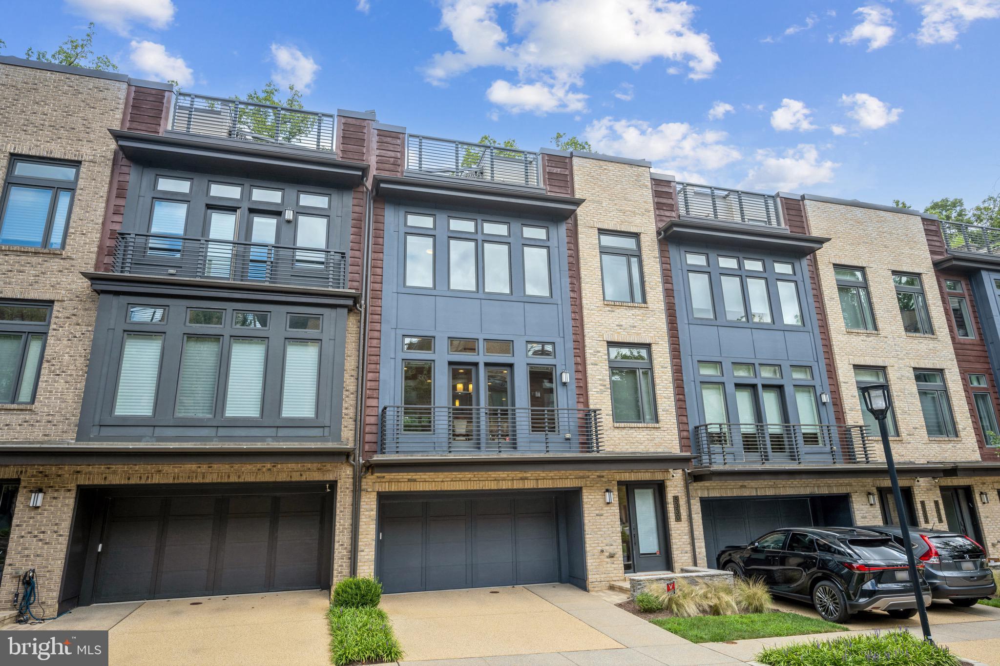 Contemporary EYA-built elevator townhome located in Bethesda's upscale Grosvenor Heights community near shopping, restaurants and Metro. This luxury residence offers expansive, sunlit living space on 4 levels ... and is the ultimate answer if you're looking to downsize, rightsize or just enjoy low-maintenance luxury living. Presented in pristine condition, this home provides more space than many single-family homes. Ten-foot ceilings, walls of large windows, balconies, a huge roof deck, a small yard, quartz countertops, Thermador appliances, open stairwells, upscale lighting and fixtures, and large walk-in closets - combine to make this is an outstanding residence. Enjoy a wonderful open floor plan; a gorgeous kitchen with expansive center isle and loaded with amenities; a large family room with fireplace and balcony, and a generous dining room. The luxurious primary bedroom suite offers a beautiful ensuite bath and walk-in closet. A separate laundry room is on the bedroom level, along with 2 additional bedrooms. The sensational roof deck offers a gas fireplace and sweeping views, for the best in entertaining under the sky! An entry level suite is currently set up as a home office but can be easily converted to a bedroom with en-suite bath and access to a grassy enclosed yard. Pull into the oversized 2-car garage to access the house and use the elevator; your guests can park easily in the front. Given its amenities and ideal location near shops, Metro, restaurants, hiking trails and award-wining schools - this truly is your best choice in today's market. Come and see!