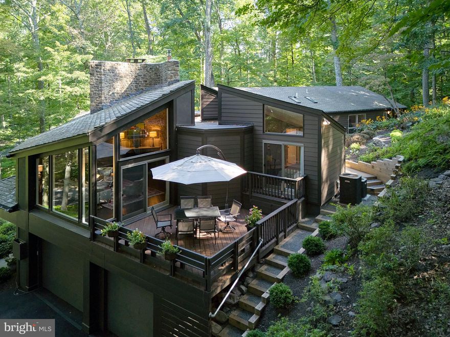 Welcome to 6891 Fleecydale Road New Hope, PA.  When renowned mid-century modern architect Frank Weise was commissioned to design Stream Woods, he had the extraordinary vision to perfectly position the house on the 4.27 acre lot in order to best capture the visual beauty of the naturally wooded terrain, the waterfall and the Paunnacussing Creek.  The spectacular views from every window create a seamless transition, bringing the outdoor space inside.  In addition to the four bedrooms and three and one half bathrooms, this architecturally significant property offers three large and adjoining outdoor living spaces. These spaces, located off the kitchen, living room and primary suite, offer unparalleled entertaining options. Expansive recent renovations include an addition,  increasing the square footage of the primary suite, the creation of an enclosed screened porch, a remodeled primary suite bathroom, new flooring, the removal of exterior stucco, replaced by the installation of Hardi-Plank siding, and an elevator which travels from the garage to the main floor living space. This property offers a level of sophistication, design, style and location rarely available anywhere in Bucks County.