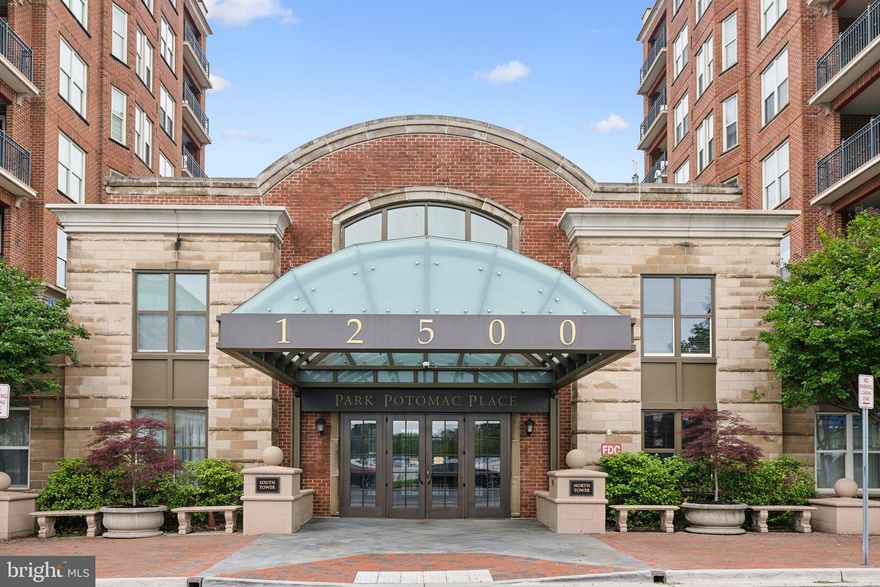 FANTASTIC NEW PRICE! 
Luxury and location are combined in this sophisticated 2 bedroom, 2 ½ bath residence in premier Park Potomac. Offering nearly 1,500 square feet of beautifully designed living space, this Manchester model features expansive open concept living and dining areas thoughtfully designed for both entertaining and everyday comfort. The open gourmet kitchen offers a seated breakfast bar, granite countertops, rich wood cabinetry, high-end Viking and Sub-Zero appliances and gas stove, perfectly suited for any home chef. Just off the main living area, oversized windows fill the space with warmth and light.
The generous primary suite is a peaceful retreat, offering a generous walk-in closet and a spacious en-suite bathroom with dual vanities, soaking tub, separate glass-enclosed shower and separate water closet. The second bedroom also features its own private bath and ample closet space, making it ideal for guests or home office. A separate powder room for guests and a true laundry room adds to the easy living.
Park Potomac Place offers everything you’ve been searching for right outside your front door including a vibrant mix of shops and award winning restaurants, grocery store, coffee shops and so much more. Upscale amenities include 24/7 concierge, a fitness center, guest suites, resident lounge and party room, private meeting rooms, beautiful outdoor pool, park, outdoor grill, shared EV chargers, on-site management, building engineer and porter service.
Easy access to 270 , 495 and major commuter routes, you’re minutes from Bethesda, downtown DC, and three major airports.
Unit 105 includes one assigned garage parking space and is pet-friendly. Whether you’re downsizing, investing, or simply looking for refined, maintenance-free living in one of Potomac’s most desirable communities, this home offers a rare opportunity to experience it all.