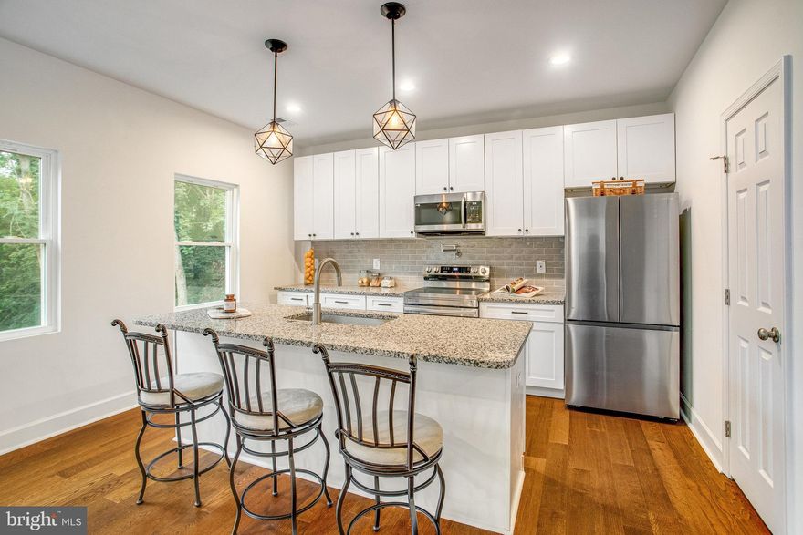 ***$3k credit to buyer with full price offer ratifed before 12/31/24.***Welcome to this brand-new gem in Belle Hill Estates, located in Historic Dumfries. Offering 4 bedrooms, 4 bathrooms, and a total of 2,352 square feet of living space, this home is designed to meet your every need. Don’t miss out on this unique chance—this is the ONLY completed new construction single-family home with no HOA fees! It also backs to lush trees; it's in a Resource Protected Area so no one can build behind you! As you step inside, you'll be greeted by a bright and open living room and a multi-purpose flex area, ready to transform into your perfect home office, formal dining space, or playroom. The kitchen is a true focal point, featuring a large island with seating, pantry with extra storage, sleek granite countertops, soft close cabinetry, and stainless steel appliances including a pot filler! Enjoy meals in your dining room overlooking the lush trees through your sliding glass door. The dining room area flows naturally into the family room, creating an ideal setup for entertaining or quiet evenings at home. The main floor impresses with 9-foot ceilings with recessed lighting and elegant engineered hardwood flooring throughout. Head upstairs to the spacious primary bedroom, designed with a tray ceiling, ceiling fan, two large walk-in closets for ultimate convenience. The primary bathroom provides a retreat-like experience, featuring granite countertops, double sinks, a soaking tub, and a separate shower. Enjoy the dual access to the laundry room, one from your bedroom and one from the main hallway.  The second floor also includes three more bedrooms, all equipped with ceiling fans, and two of which have walk-in closets and share an en-suite bathroom. All the bathrooms are tastefully designed with beautiful tile and granite finishes. This home comes with a spacious two-car attached garage. Enjoy a tankless water heater that lowers your utility bills!  Located just a half mile from the now-open $460 million entertainment and gaming development that includes a luxury hotel, restaurants, cultural venues, and over 80 acres of green space with trails and recreational facilities, this area offers exciting nearby attractions. Easy access to Rts. 1, 234, I-95/HOT lane access for Pentagon and DC. Conveniently located to commuter lots, VRE and Amtrak. Short drive to Quantico Marine Base, Prince William Forest Park, Leesylvania State Park, Belmont Bay Marina, Potomac Mills Mall, Stonebridge Shopping Center with a Wegmans, and more! This is your chance to own a newly built home with all the modern amenities in a sought-after location—come experience it for yourself! 5 year structural, 1 year workmanship builder warranty. ***When driving to the property, do NOT follow your GPS. It's a new development so it's not known yet. From Rt. 1, make a right onto Washington St. Keep going up the hill until you see the Belle Hill Estates sign.