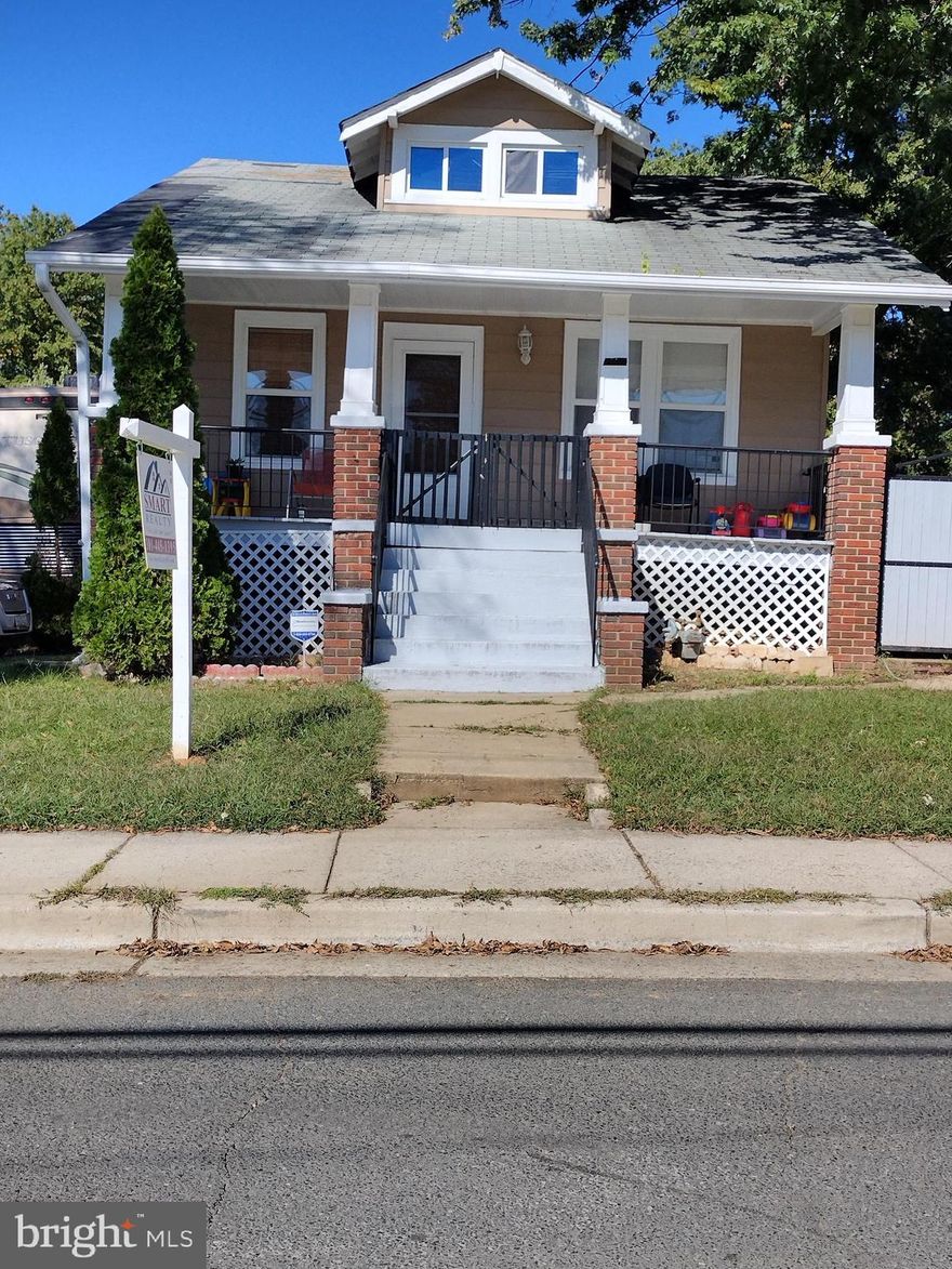 Make this Bungalow your own.  This home has a total of 6 bedrooms, and 3 full bath. Finished basement with walk-out stairs, and an extra kitchenette. Wood floors throughout the main level. Huge front porch. Plenty of parking.