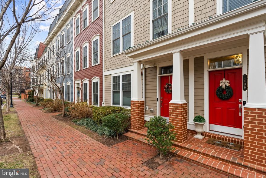 Welcome to 1409 Van Valkenburgh Lane, a beautifully maintained and thoughtfully updated four-level townhome in a quiet portion of Potomac Yard with easy walkability to Del Ray and Old Town Alexandria. 
Tucked on a serene, low-traffic street with wonderful neighbors, this modern residence offers exceptional versatility, abundant storage, and two inviting outdoor spaces, including a stunning top-level terrace with a rare double-sided indoor/outdoor fireplace.
The entry level features a private bedroom with full bathroom, ideal for guests, au pair, or in-law suite, or a home office, along with access to the two-car garage, complete with an upgraded epoxy-coated floor and the ability to easily add an  EV charging station. 
Upstairs, the main level, the true heart of the home, boasts an open living, dining, and kitchen layout filled with abundant natural light. The kitchen is beautifully appointed with quartz countertops, stainless steel appliances, ample custom cabinetry, a large breakfast bar, and a charming balcony just off the kitchen. Enjoy coffee, wine or al fresco dining directly off the kitchen. A powder room and gleaming hardwood floors complete this level. Additional updates include designer lighting with upgraded dimmers.
The bedroom level offers two additional bedrooms, each with their own full bathroom, perfect for privacy. The primary suite includes two large custom closets and a generous spa-inspired en-suite bath with a double vanity and new faucets. The second upper-level bedroom features a high-quality Murphy bed with a built-in desk that maximizes space and versatility.
The showstopping fourth floor is perfect for entertaining or relaxing. This loft-level recreation room includes a wet bar, a washer/dryer area, and opens to the expansive rooftop terrace, made even more special by the indoor/outdoor double-sided gas fireplace, a rare and luxurious touch. This level benefits from a new HVAC system serving levels 3 and 4, paired with Honeywell thermostats for dual-zone efficiency. Additional home updates include an alarm system and ceiling fans in the loft, living room, and all bedrooms.
Residents will love this home for its peaceful setting, abundant storage, and convenient location.
Located in a highly desirable section of Potomac Yard that is Del Ray adjacent, this home is moments from beloved shops, restaurants, health clubs, cafés, and parks. Old Town Alexandria is an easy stroll and both Braddock Road and Potomac Yard Metro stations are less than a mile away.  DCA Airport is just two stops by Metro or a 12-minute drive, and Crystal City, Pentagon City, and Washington DC are all close by. 
Enjoy all the charm Alexandria offers: historic streets, stunning architecture, vibrant community events, excellent services, and beautiful Potomac River scenery.
This exceptional townhome combines modern comfort, thoughtful upgrades, and unbeatable convenience, an opportunity not to be missed.  Welcome home!