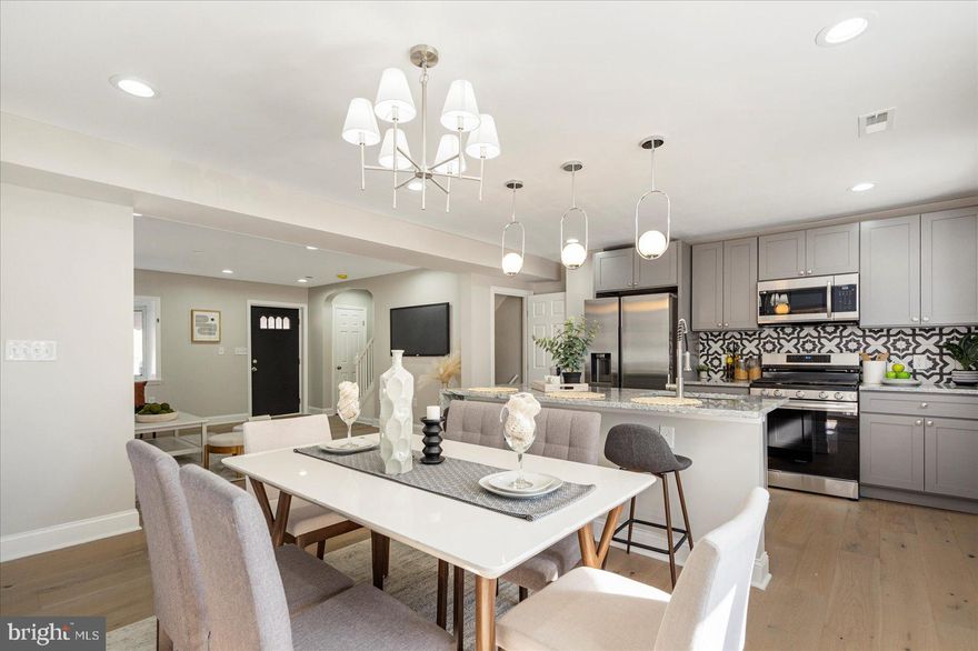 Newly remodeled 3BR/2BA brick Townhome located in the quiet neighborhood of Loch Raven.  Walk past a lush green lawn on the way to the covered front porch and open the door into your forever home. As you step inside, an open concept floor plan greets you with tons of natural light, beautiful wide plank flooring, and a soft color pallet.  The large living room features a bay window with a deep sill ideal for house plants. The flow of the main floor allows you to entertain with ease in the dining room and gorgeous kitchen.  The stunning kitchen features plenty of cabinets, stainless steel appliances, beautiful granite countertops with a decorative tiled backsplash, and a stainless sink set into a large island featuring a waterfall edge, seating, and pendant lighting above.  On the second floor are two primary sized bedrooms, a sizable secondary bedroom, and a newly remodeled full bath.  A hidden staircase takes you to a semi finished attic space ideal for storage or a childs play area.  The lower level offers additional living space featuring a family room, full bath with walk-in shower, laundry, storage, and a walk-out to a covered patio in the pristinely maintained yard. From the kitchen step out onto a spacious deck that overlooks the amazing fenced yard space with a parking pad for two cars.  This home is move-in ready with so much to offer new homeowners including new flooring, recessed lighting and fixtures, and so much more.  Imagine all this and in close proximity to shopping, restaurants, and commuter routes.