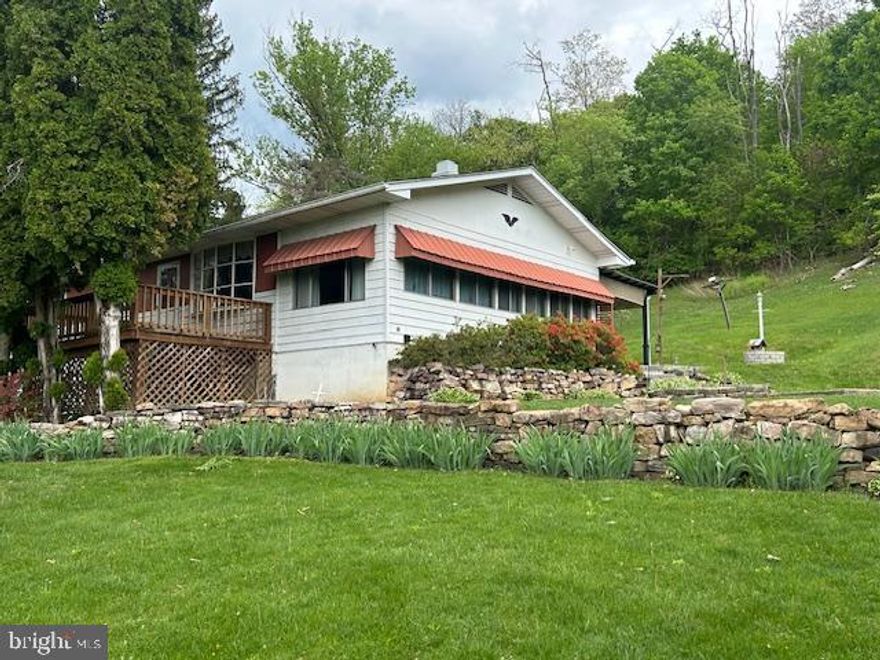 PRICE REDUCED! Enjoy a home in the country in this ranch home on .69 acres. The home is located just under 3 miles from Lewistown and has lots of yard and garage space for your past times. The ranch home has so much potential and includes three bedrooms, one full bath with tub/shower combination, a living room with wood floors and access to the front deck, and a galley kitchen with eat-in dining. A private back porch overlooks the yard with the woods behind it and lots of space to plant a small garden. The hobbyist will love the two story garage with a full workshop on the top floor (equipment not included) and the lower level can be used as a garage or storage area. Many possibilities in this building! Find your home in the country! PLEASE NOTE: HOME IS BEING SOLD "AS IS".