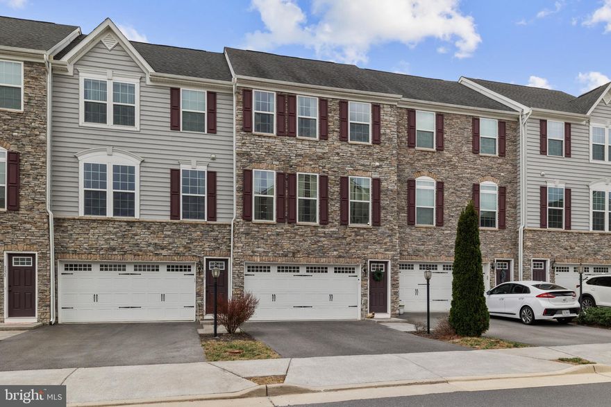 Welcome to this stunning stone-front townhome in the highly sought-after Lake Frederick community. This beautifully maintained home offers 3 spacious bedrooms and 3.5 bathrooms, featuring a thoughtfully designed open-concept layout. The main level showcases gorgeous engineered hardwood floors and a gourmet kitchen equipped with stainless steel appliances, abundant cabinet space, and a large kitchen island, perfect for meal prep and entertaining. Recessed lighting throughout adds a modern touch to the space.
The bright and airy dining area opens to a deck, offering serene views and an ideal space for relaxation or al fresco dining. The cozy living room, adjacent to the kitchen, creates the perfect environment for casual gatherings. Upstairs, the carpeted bedrooms provide a comfortable retreat, including a luxurious primary suite with an ensuite bathroom for ultimate convenience and privacy.
The lower level offers flexible living space, complete with a full bathroom, perfect for guests or additional living needs. Step outside to the impressive deck and partially fenced rear yard, offering privacy and a peaceful atmosphere. The 2-car garage and additional driveway parking provide ample space for vehicles. Backing to the lake, enjoy breathtaking views and an excellent location within the community. This home is truly a must-see! Book your tour today!
