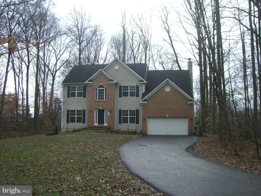 Colonial on 1/1/2 acre in the heart of Gambrills, 2 car garage with plenty of drive way parking, 4 large bedrooms with loads of closet space. Gas fireplace in family room. Eat-in-kitchen with center isle, hardwood floors in foyer, kitchen and dining room. Newer carpet thru-out. First floor laundry. Ceramic tile in all baths and double sinks in master and hall bathrooms.  Recently paved driveway.