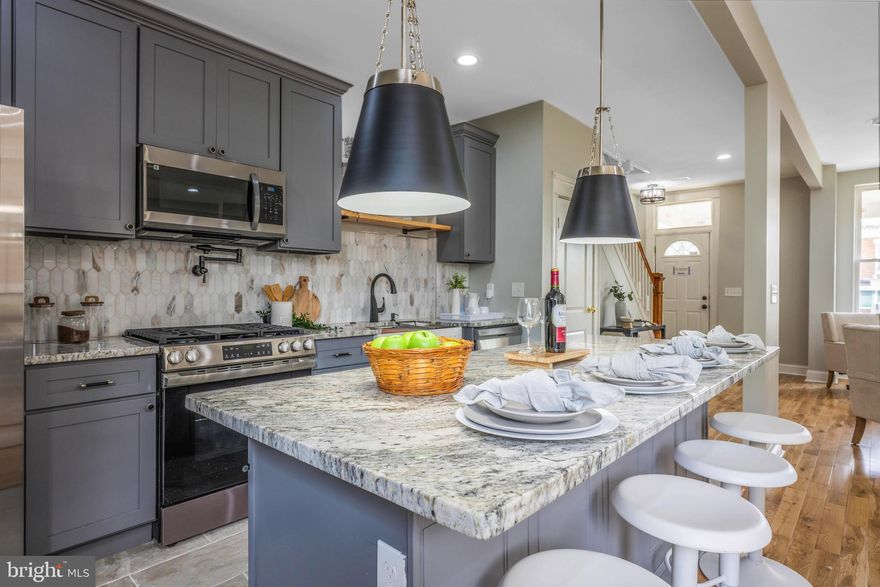 This fully renovated 4-bedroom, 2-bath home features brand-new electrical, plumbing, and HVAC systems, along with hardwood floors throughout (NO CARPET), and porcelain tiles in the basement. The modern kitchen is fully equipped with high-end finishes, and the finished basement includes an additional bedroom and full bathroom—ideal for guests or extended living space. Enjoy a private, fenced-in yard, a rear parking pad, and a welcoming front porch. Conveniently located near Morgan State University and Johns Hopkins University. Schedule your private tour today!