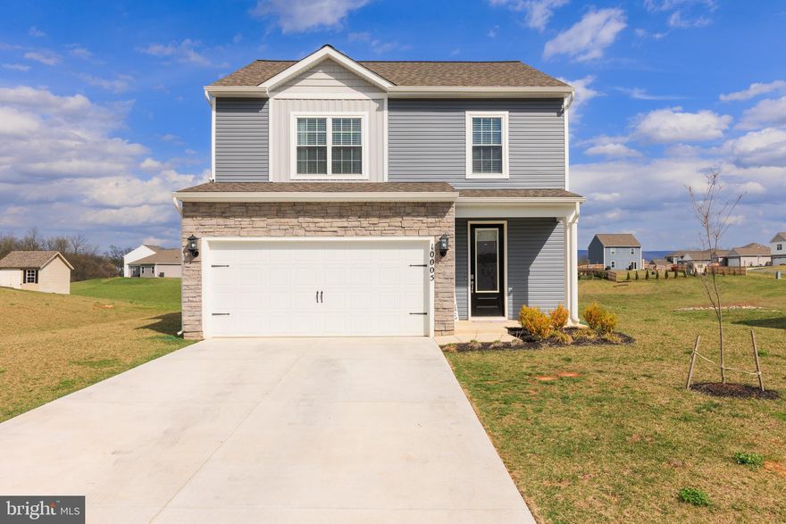 This beautifully maintained stone-accented Colonial, built in 2023, offers 4 bedrooms, 2.5 bathrooms, 1,848 finished square feet, a 2-car garage, and sits on nearly half an acre in picturesque Claggetts Mill. The bright and airy interior begins with a welcoming foyer featuring direct garage access and a conveniently located powder room. The open-concept main level includes a spacious family room, a dining area with sliding glass doors to the backyard, and a beautifully appointed eat-in kitchen with upgraded countertops, stainless steel appliances, a built-in range, pantry, oversized island with bar seating, and classic white subway tile backsplash. Upstairs, you’ll find 4 comfortably sized bedrooms, 2 full bathrooms, and a convenient laundry area. The primary suite features soaring vaulted ceilings, a walk-in closet, and a private en-suite bathroom with an extended vanity. Enjoy outdoor living in the large backyard with a patio area, perfect for grilling, entertaining, or relaxing while taking in the peaceful setting. Conveniently located near shopping, dining, and commuter routes, this newer home offers the perfect combination of modern finishes, space, and functionality.
