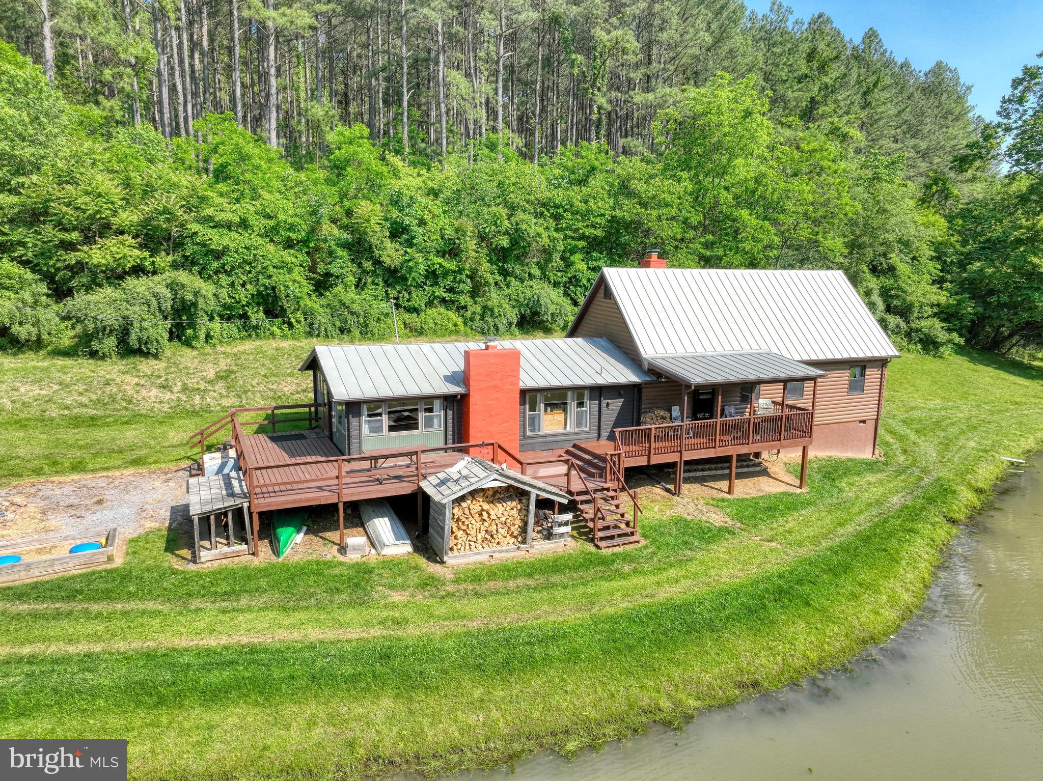 Seeking peace and quiet? You’ve found it.
Updated in 2019 with a beautiful addition and new roof, this charming 3-bedroom (plus loft), 1-bath log home is nestled on more than 23 acres of natural beauty. Featuring an open floor plan, hardwood floors, wood ceilings, and rustic log walls, the home offers cozy living with a spacious feel. Enjoy 2 wood-burning fireplaces (one with a wood stove) and an expansive deck perfect for taking in the serene surroundings.
The property boasts a spring, a creek running through it, and a stocked pond—ideal for nature lovers and outdoor enthusiasts. Multiple covered viewing stands on the property for watching wildlife. Located within walking distance of the Shenandoah National Park. No HOA. Furnishings can convey.
Don’t miss this unique retreat!