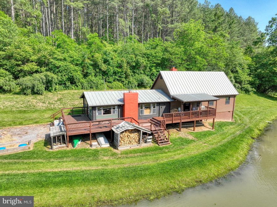 Seeking peace and quiet? You’ve found it.
Updated in 2019 with a beautiful addition and new roof, this charming 3-bedroom (plus loft), 1-bath log home is nestled on more than 23 acres of natural beauty. Featuring an open floor plan, hardwood floors, wood ceilings, and rustic log walls, the home offers cozy living with a spacious feel. Enjoy 2 wood-burning fireplaces (one with a wood stove) and an expansive deck perfect for taking in the serene surroundings. 

The property boasts a spring, a creek running through it, and a stocked pond—ideal for nature lovers and outdoor enthusiasts. Multiple covered viewing stands on the property for watching wildlife. Located within walking distance of the Shenandoah National Park. No HOA. Furnishings can convey. 

Don’t miss this unique retreat!