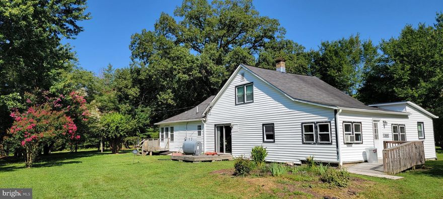 Charming farmhouse on over 6 acres! Bring the horses and chickens! There are so many opportunities with this property. The lot already has a large portion cleared in the back, perfect for a pasture or garden. Beautiful flowering trees, a peach tree and a pear tree. Large pole barn carport has plenty of room for your RV, boat, lawn or farm equipment. There is an old chicken coop and additional shed. The home is handicap accessible with a ramp to the front door, main level bedroom, walk-in shower and half bath. Three additional bedrooms upstairs. House has been partially updated over the years to include new windows, new roof, new well & septic and updated bathrooms.  Needs a little TLC but there is so much potential!! Being sold strictly "AS IS". Conventional financing, Cash or Rehab loan only.