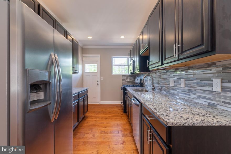 INCREDIBLE OPPORTUNITY TO OWN THIS NEWLY RENOVATED ROWHOME WITH 3 FINISHED LEVELS FOR UNDER 200K!  Features include hardwood floors and crown molding throughout the main level, spacious living room, designer kitchen w/ granite counters, ss appliances, and glass tile backsplash, main level half bath, upper level w/ 2 large bedrooms , 1 full bath, and bedroom level laundry, finished basement w/ 2 bedrooms and 1 full bath, and a rear deck overlooking the fenced yard.  Perfectly located close to UMMC, stadiums, and major roadways!  TONS OF DOWN PAYMENT ASSISTANCE PROGRAMS AVAILABLE - ASK FOR DETAILS!