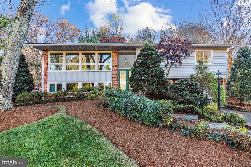 Welcome home to 813 Downs Drive, a bright and airy four bedroom, three bathroom contemporary in the sought after neighborhood of Springbrook Terrace.  As you approach, the first thing you’ll notice is the professionally landscaped yard, mature plantings, and slate walkway leading up to the house. The upper level has beautiful hardwood floors and recessed lighting throughout. The living room is bathed in sunlight and has a beautiful exposed brick wall with a fireplace.   The living room leads into the dining room which makes these two spaces ideal for entertaining. The oversized eat-in kitchen boasts granite countertops, stainless steel appliances and in addition to space for a table, it has a cozy sitting nook with a second fireplace.  The backdoor from the kitchen leads right to the private deck and secluded backyard, the perfect spot for grilling, morning coffee or evening wine. The spacious primary bedroom has a large sitting/dressing area, multiple closets including a large walk-in, and a private bathroom.  Two additional bedrooms and a full hall bath complete the upper level. The lower level family room has custom built-ins, new carpet and plenty of windows to let in the light. The laundry room houses lots of built in shelving for storage, and an additional refrigerator. The lower level is also host to a fourth bedroom, full bath, cedar closet and garage.  Recent improvements include new carpet and paint throughout. Convenient to shopping, restaurants, Martin Luther King Park, 495 and the ICC.