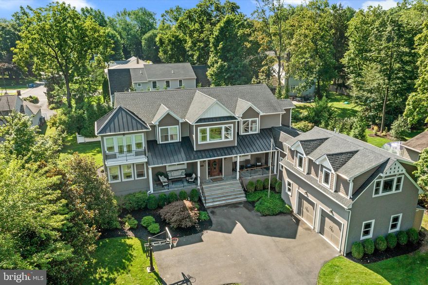 Welcome to 500 E Court Street! The original circa 1911 home was reimagined in 2013 with a complete renovation and expansion that resulted in this stunning and spacious, turnkey home that boasts approximately 5,000SF and modern-day amenities. 5 en suite bedrooms with walk-in closets, including a private guest suite over the 2-car garage.  Walking distance to the center of Doylestown and located across the street from the historic Fonthill Castle, nestled on 70 acres of lush grounds.  You cannot beat this location! Enter the driveway, adorned by columns, as you head into a spacious courtyard. The inviting covered porch with two sitting areas that flank the gorgeous 8 ft oak front door that welcomes you into the home.  Upon entering the home, you will immediately notice the light and airy feeling and the open floor plan with 9 ft ceilings, gorgeous smoked hickory wood flooring and oversized windows with deep sills. The foyer is flanked by a spacious dining room and living room with a two-way gas fireplace. Located just beyond the living room is a relaxing sunroom/family room with French doors that provide access to one of the covered porch areas. Tucked away beyond the living room and family room is a wonderful pub room/flex space, complete with a bar area with beer tap where you can enjoy the other side of the two-way fireplace that is shared with the living room. This room is also a great space for a home office/study.  The custom kitchen features rustic maple soft-close cabinets, new honed quartzite countertops, subway tile backsplash, under cabinet lighting, stainless steel appliances that include a six-burner gas range with a custom hood vent, dual ovens, custom pendant lighting above the island and recessed lighting. The kitchen also includes banquet seating for 8 and a built-in desk area. The kitchen provides access to the deck, which is the perfect area for grilling and dining al fresco. The spacious ½ acre lot provides an abundance of outdoor space that includes an expansive backyard. There is plenty of space for the next steward to customize the great outdoors to suit their needs.  There are endless possibilities to explore.  Back inside the house, just past the kitchen there is a butler pantry with a wine refrigerator, a huge walk-in pantry with secondary refrigerator-freezer, a large laundry/mud room with cubbies, access to an additional covered porch area. Continue down the hall to the 2-car garage with custom storage bin and rack system. Above the garage, a private staircase leads to a spacious 5th en suite bedroom with a living room. A perfect space for in-law, au pair or guest suite, that is separate from the main living quarters of the home. Head upstairs to the 2nd level of the main living quarters via either the main staircase or back staircase near the kitchen. There is a lovely sitting area at the top of the main staircase. The spacious primary bedroom suite with a double tray ceiling with lovely sitting room with French doors to a balcony that overlooks the front courtyard and greenery of the Fonthill estate. The primary suite bathroom includes radiant heated floors, a dual vanity, an oversized tiled shower with glass enclosure, a soaking tub, private water closet, linen closet and access to the spacious walk-in closet with custom built-ins. Just down the hall there are 3 additional large en suite bedrooms each with combination tub-showers and custom walk-in closets. The lower level provides a large finished area that is the perfect space for a game room, craft room, gym and more. There is also a large unfinished area that is great for storage. 3-Zone HVAC, 6-Zone Irrigation System and Central Vac. Enjoy all that Doylestown Borough offers – wonderful restaurants, shops, museums, county theater, parks and various festivals. Doylestown is rich in history and the arts.  Close in proximity to major routes and walking distance to everything, including mass transit.