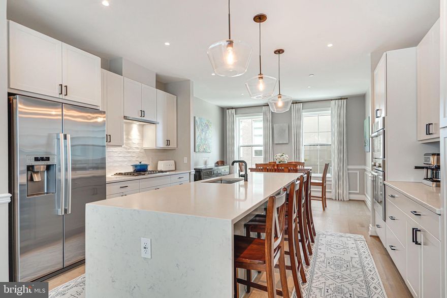 Welcome to your dream home, featuring an array of custom touches and luxurious upgrades designed to provide the ultimate in comfort and style.

As you step into the garage, you'll find mounted wall racks and overhead storage, offering ample space for all your storage needs. The first floor boasts a custom-built office with custom built-in, perfect for remote work or study, and a custom mudroom cabinetry conveniently located next to the front door.

The kitchen is a chef's delight, equipped with stainless steel Bosch appliances and the largest waterfall/oversized kitchen island available. Custom molding enhances the entrance stairs and living room, while custom drapes and Roman shades add a touch of elegance throughout. The kitchen island also features an upgraded wine/beverage fridge that can hold up to 42 bottles, perfect for entertaining.

The home includes custom runners on the stairs, and each bathroom is adorned with majestic vanity mirrors, with the primary bath mirrors being a standout feature. The primary bedroom boasts three custom closets by Econize Closets, ensuring plenty of storage space.

The rooftop is an entertainer's paradise, complete with a built-in fridge, sink, grill, and granite counter. The home is equipped with upgraded dimmer switches, a Brilliant lighting system, and Nest thermostats throughout allowing you to create the perfect ambiance in every room, even from afar.

Throughout the home, you'll find high-end Oak plank flooring, adding warmth and sophistication to each space. This property truly offers a blend of luxury, functionality, and style, making it the perfect place to call home.