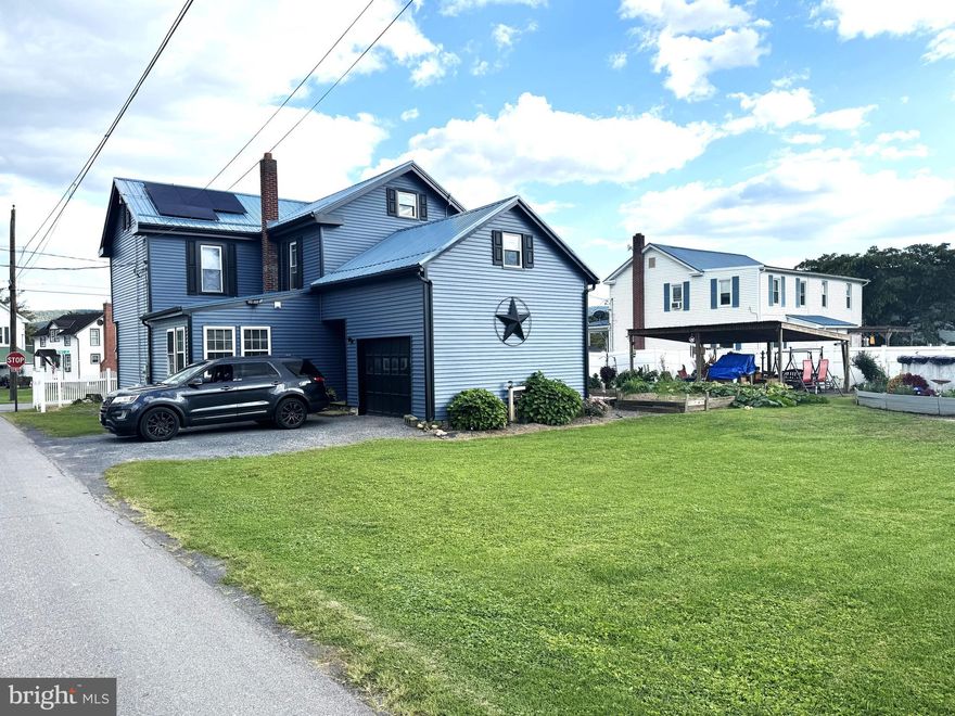 Need a home that will fit everyone? This has 5 bedrooms with 2 full bathrooms, one bedroom and bathroom are on the first floor. Big eat in kitchen with laundry room/ pantry off of kitchen. Flow through the 1st floor bathroom from laundry and bedroom. Living room is big  with front door going to the wrap around covered porch. The 2nd floor boosts 4 bedrooms and a nicely updated bathroom. The large corner lot gives you lots of space with 2 garages, a fenced in yard, covered rear patio, raised garden beds, above ground pool and a driveway. Solar panels are paid for and are connected directly to power grid. New Mini split system with 3 heads just installed for energy efficient heating and cooling.