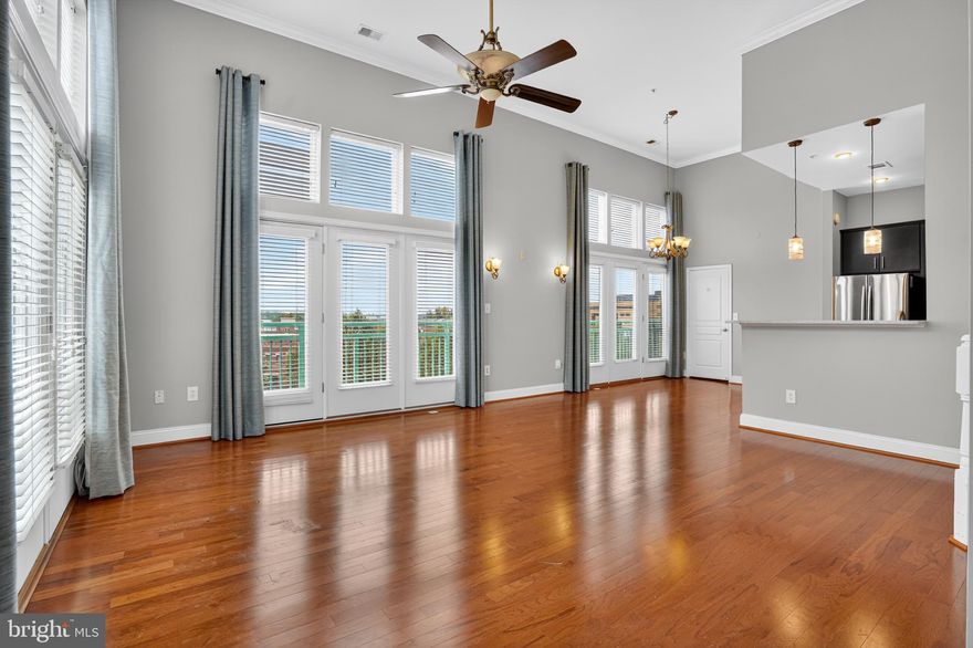 Spectacular and rarely available 2 story, 3 bed 3 bath penthouse on the top floor of the impeccably chic ‘Savoy’ in Reston town center,  This low rise, impressive boutique building with landscaped grounds is within walking distance to shops, restaurants, cinema and Silver Line Metro with direct service to Dulles Airport and DC.

Please note that  Unit 490  is very close to an elevator with quick, easy access to the St Francis street building lobby.   Also to the parking spots.  The concierge entrance  is a lengthy walk to the unit.  
                                                            
Entering this beautiful property is to enter a world of light and possibility.   The high ceiling and grand chandelier of the circular reception ushers you  into a spectacular living area.   Here  soaring ceilings and dramatic tall windows embrace the corner to showcase a wide expanse of gleaning hardwood floors extending through the gourmet kitchen and up the the circular staircase to the third en suite bedroom.  The two walls of windows and doors are graced  European style with Juliet balconies.    Sunset views are a welcome bonus.  

A distinct dining area and gourmet stainless/granite kitchen share this expansive space fitted with gleaming hardwood floors that sweep up an elegant staircase to the second level third bedroom suite complete with full bathroom - the perfect spot for an office or yoga studio perhaps? 

Few units at the Savoy share this unique combination of design elements and nowhere are they more skillfully arranged than in Unit 490.  You will be delighted with a sense of light and space and the feeling of privacy that results from no neighbors above and the quiet neighborhood outside.

You will also be thrilled to learn that two large, side by side assigned parking spaces located thankfully close to the elevator in the upper level of a secure, well lit, spacious underground garage complete the appeal of this outstanding package.

Please come visit and be enchanted.
                                                                             

Now let me introduce you to the Savoy - sublime service in an unbeatable location.

Contemporary with echoes of art deco, this architecturally interesting building with a tall dramatic entrance dominates Market Street and beckons you into an intimate circular stylish lobby, staffed by a professional concierge to answer all your questions, seven days a week.  All common areas are spotlessly clean and have been designed with artfully chosen light fixtures and decor reminiscent of first class hotels.  Refined style and thoughtfulness greet you at every turn and in every detail  - even side entrances are elegantly decorated and cleansing stations are everywhere for your convenience.

The Savoy's thoughtful and comprehensive package of amenities offers so many options for those days when you 'want to get out of the house' but feel too lazy to decide where to go or how to get there.  The many playfully named options include the Recharge Room, The Think Room, the Game Room,  as well as the Fitness Room, Media Room and extensive outdoors garden area and in summer, of course, the pool!  Many strategically placed elevators silently serve residents well.
 
This glorious property offers the advantages and flair of a grand hotel with the feel of a townhouse in a quietly luxurious and cheerfully chic condo.  Could this hidden gem be for you?